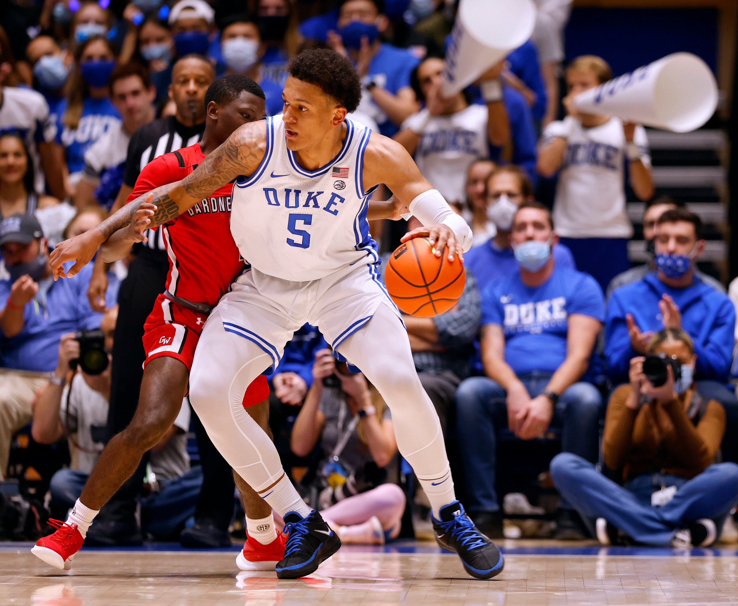 DURHAM, NORTH CAROLINA - NOVEMBER 16: Julien Soumaoro #1 of the Gardner Webb Runnin' Bulldogs defends Paolo Banchero #5 of the Duke Blue Devils during the first half of their game at Cameron Indoor Stadium on November 16, 2021 in Durham, North Carolina. (Photo by Grant Halverson/Getty Images)