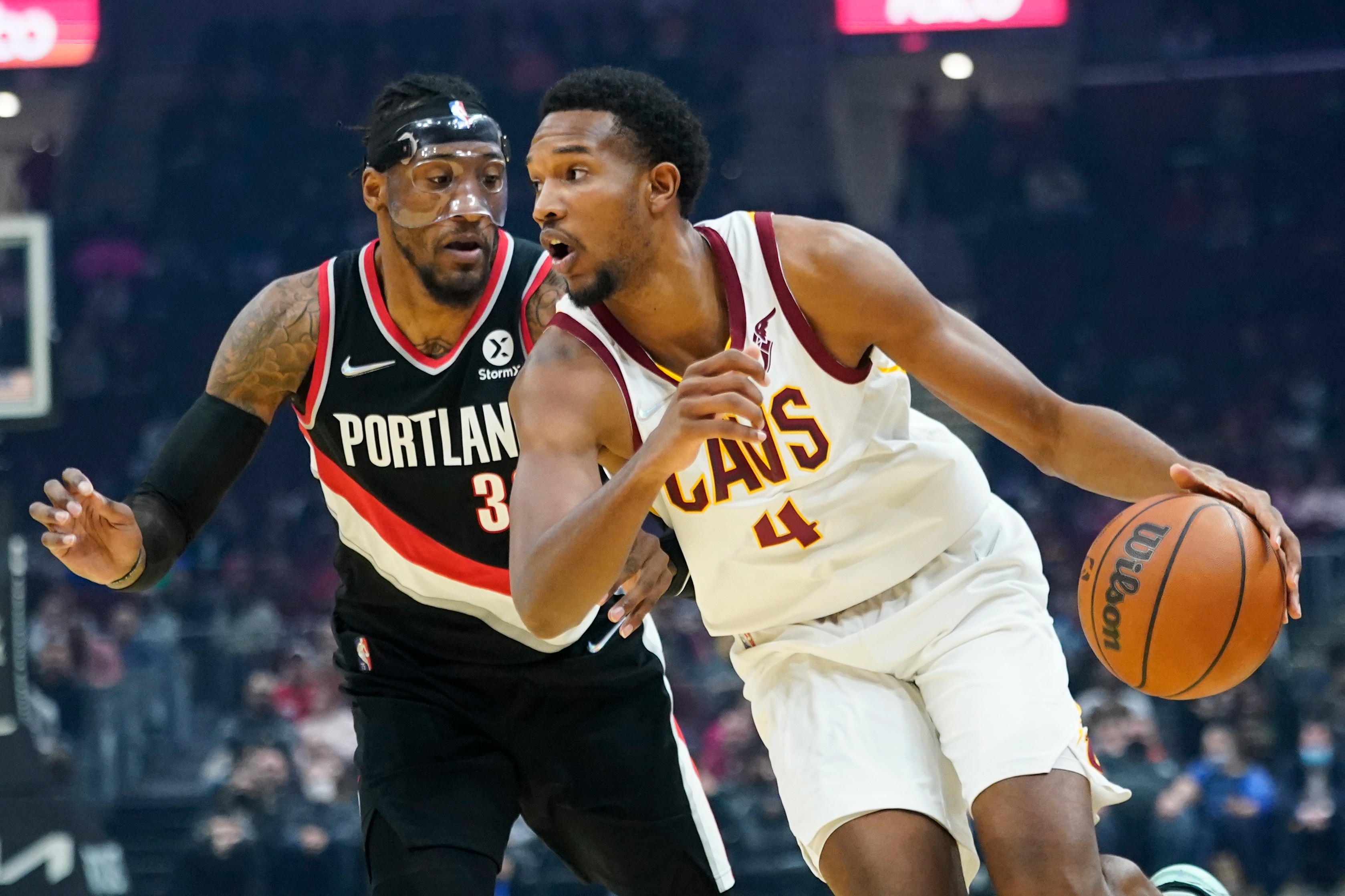Cleveland Cavaliers' Evan Mobley, right, drives past Portland Trail Blazers' Robert Covington in the first half of an NBA basketball game, Wednesday, Nov. 3, 2021, in Cleveland. (AP Photo/Tony Dejak)