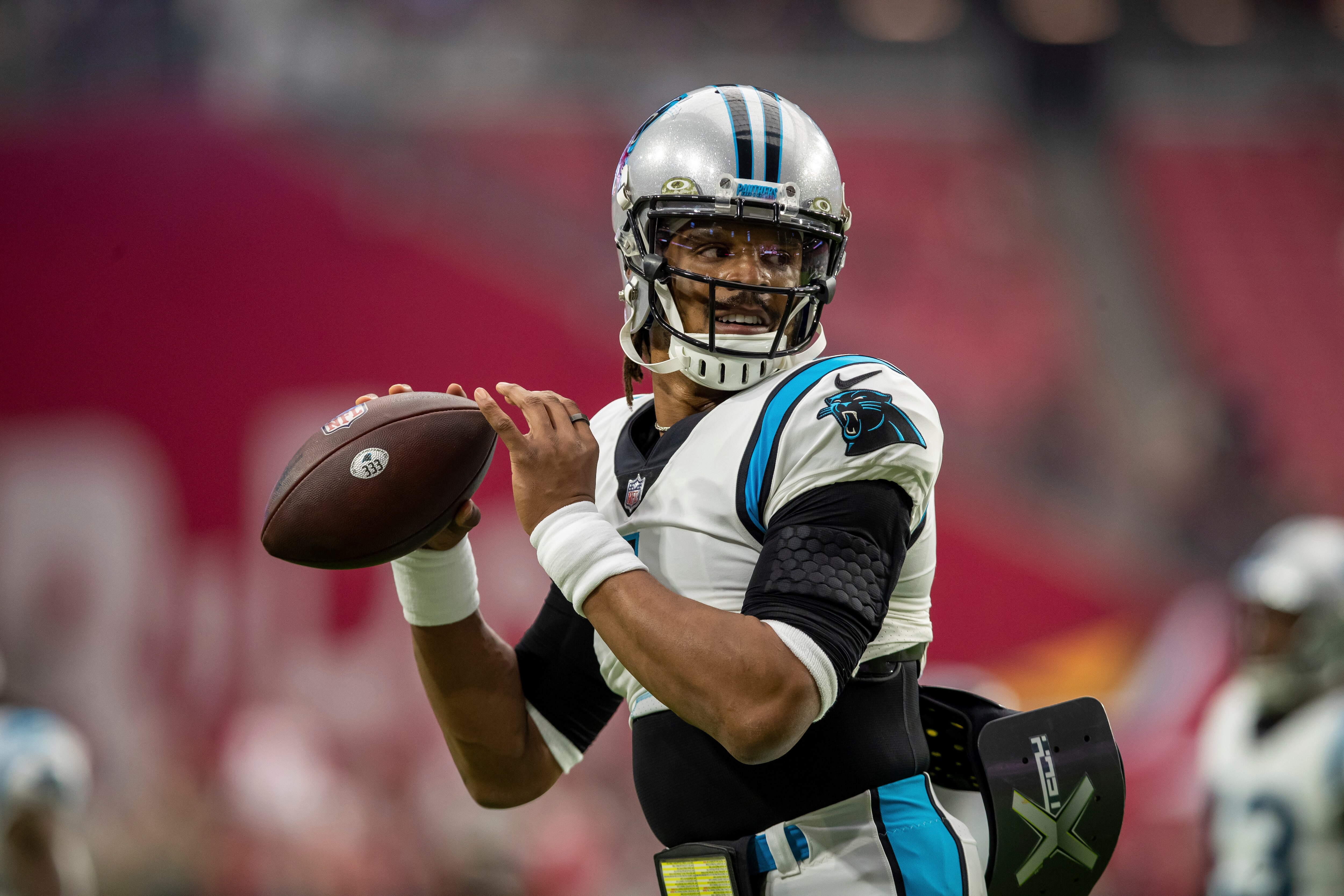 Quarterback (1) Cam Newton of the Carolina Panthers warms up before playing against the Arizona Cardinals in an NFL football game, Sunday, Nov. 14, 2021, in Glendale, Ariz. Panthers defeated the Cardinals 34-10. (AP Photo/Jeff Lewis)