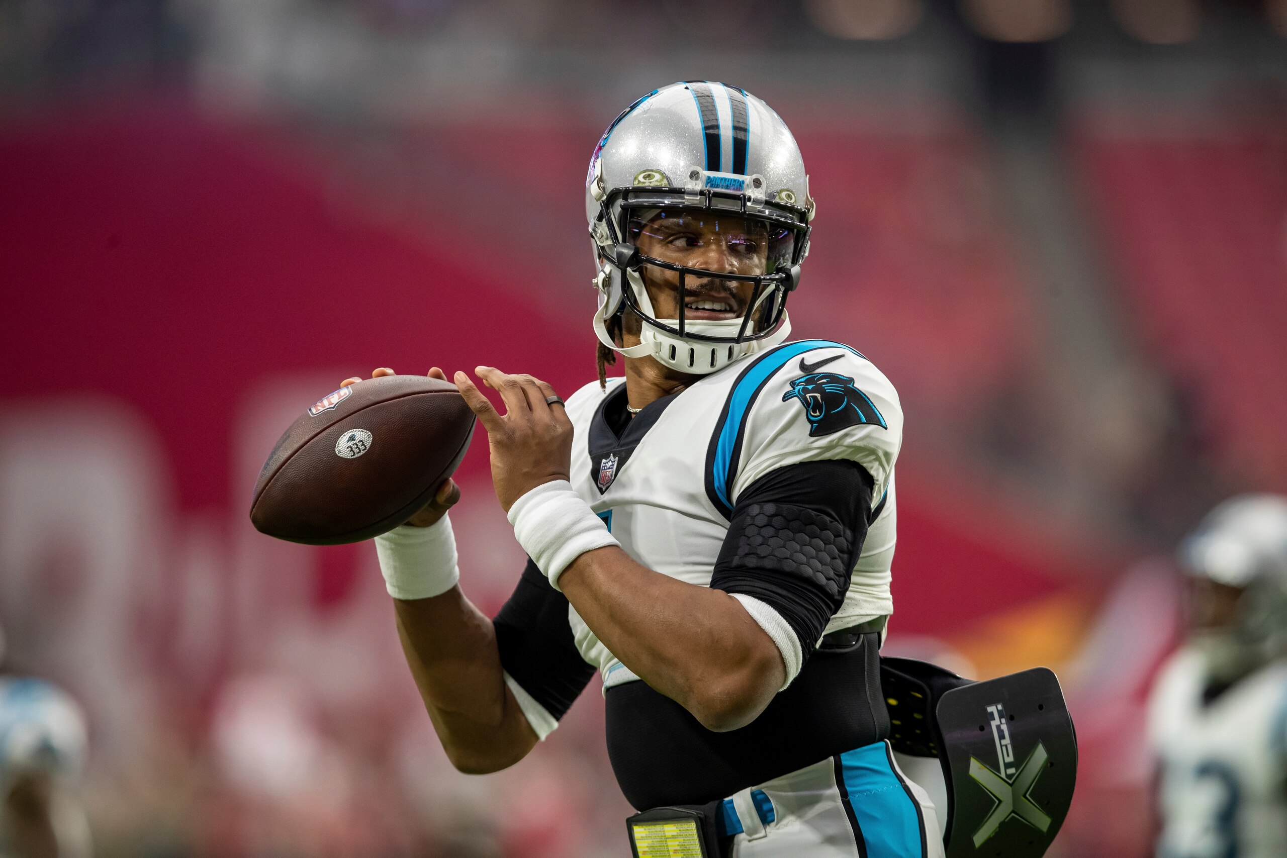 Quarterback (1) Cam Newton of the Carolina Panthers warms up before playing against the Arizona Cardinals in an NFL football game, Sunday, Nov. 14, 2021, in Glendale, Ariz. Panthers defeated the Cardinals 34-10. (AP Photo/Jeff Lewis)