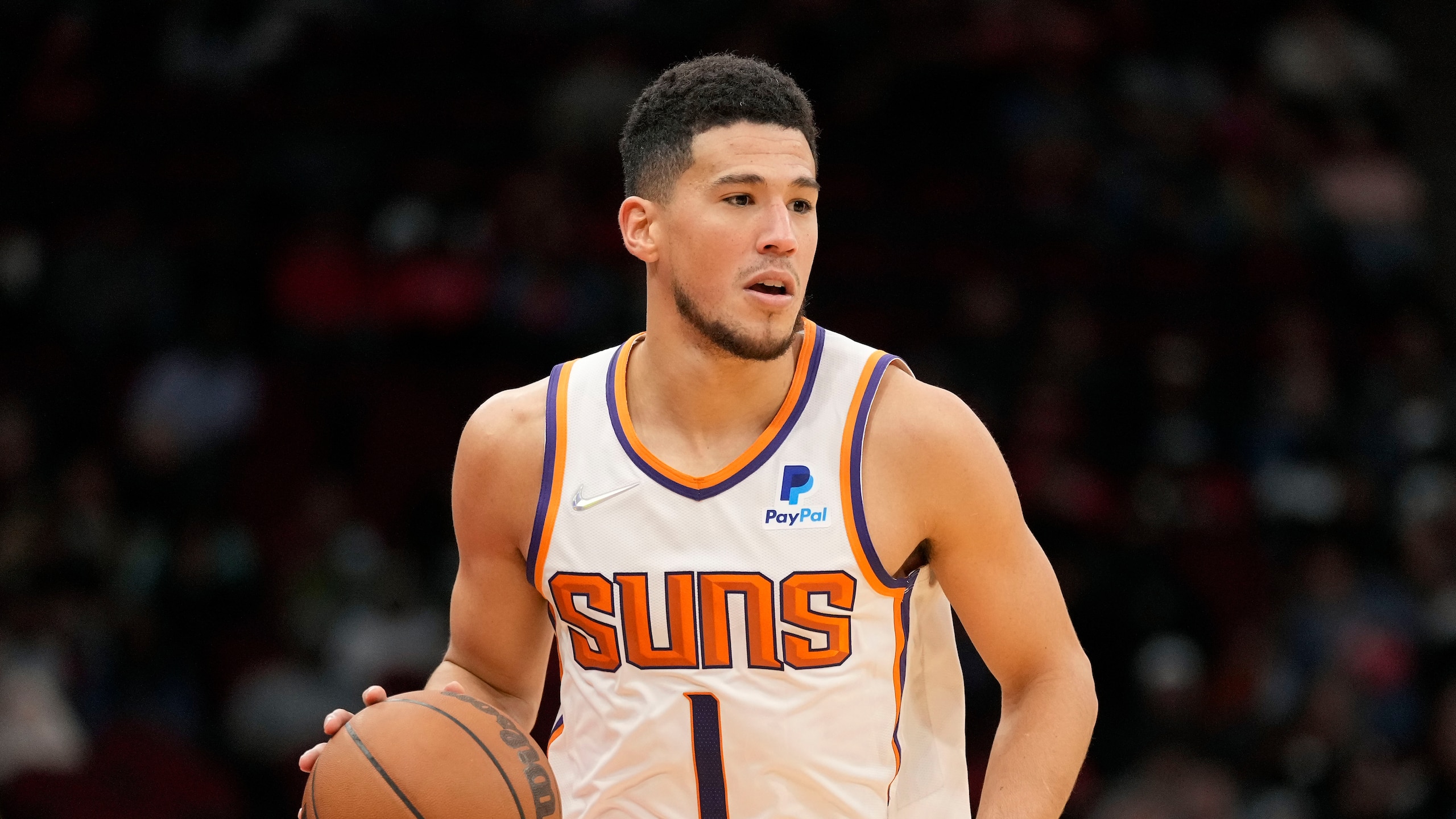 Phoenix Suns guard Devin Booker dribbles during the second half of an NBA basketball game against the Houston Rockets, Sunday, Nov. 14, 2021, in Houston. (AP Photo/Eric Christian Smith)