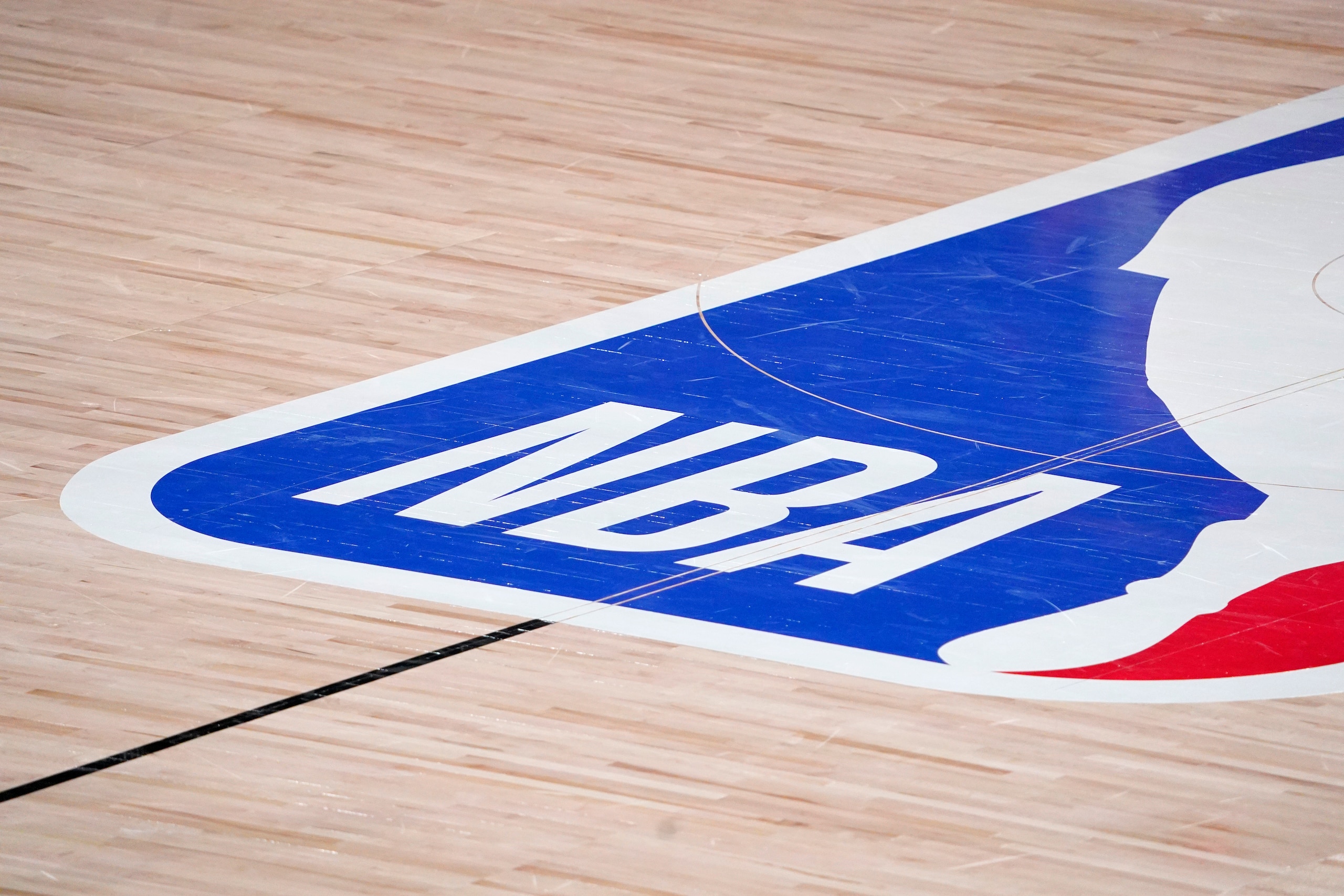 The NBA logo at center court is shown during the second half of an NBA first-round playoff basketball game between the Houston Rockets and Oklahoma City Thunder in Lake Buena Vista, Fla., Wednesday, Sept. 2, 2020. (AP Photo/Mark J. Terrill)