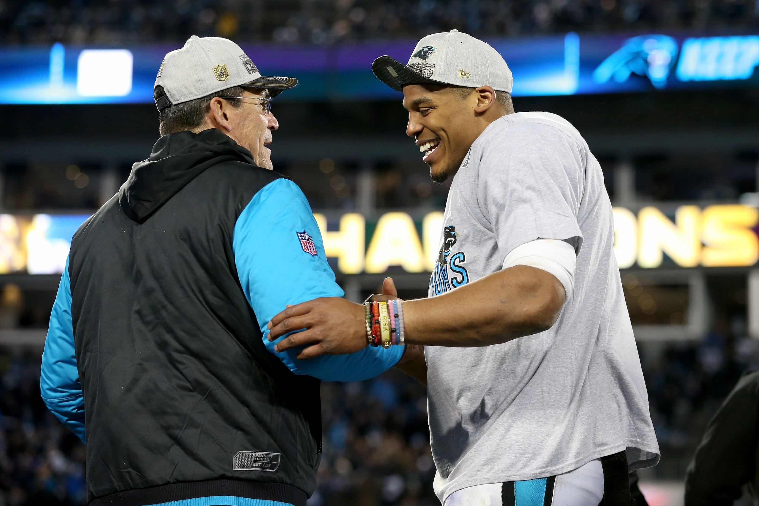 CHARLOTTE, NC - JANUARY 24:  Head coach Ron Rivera of the Carolina Panthers celebrates with Cam Newton #1 after defeating the Arizona Cardinals with a score of 49 to 15 to win the NFC Championship Game at Bank of America Stadium on January 24, 2016 in Charlotte, North Carolina.  (Photo by Streeter Lecka/Getty Images)