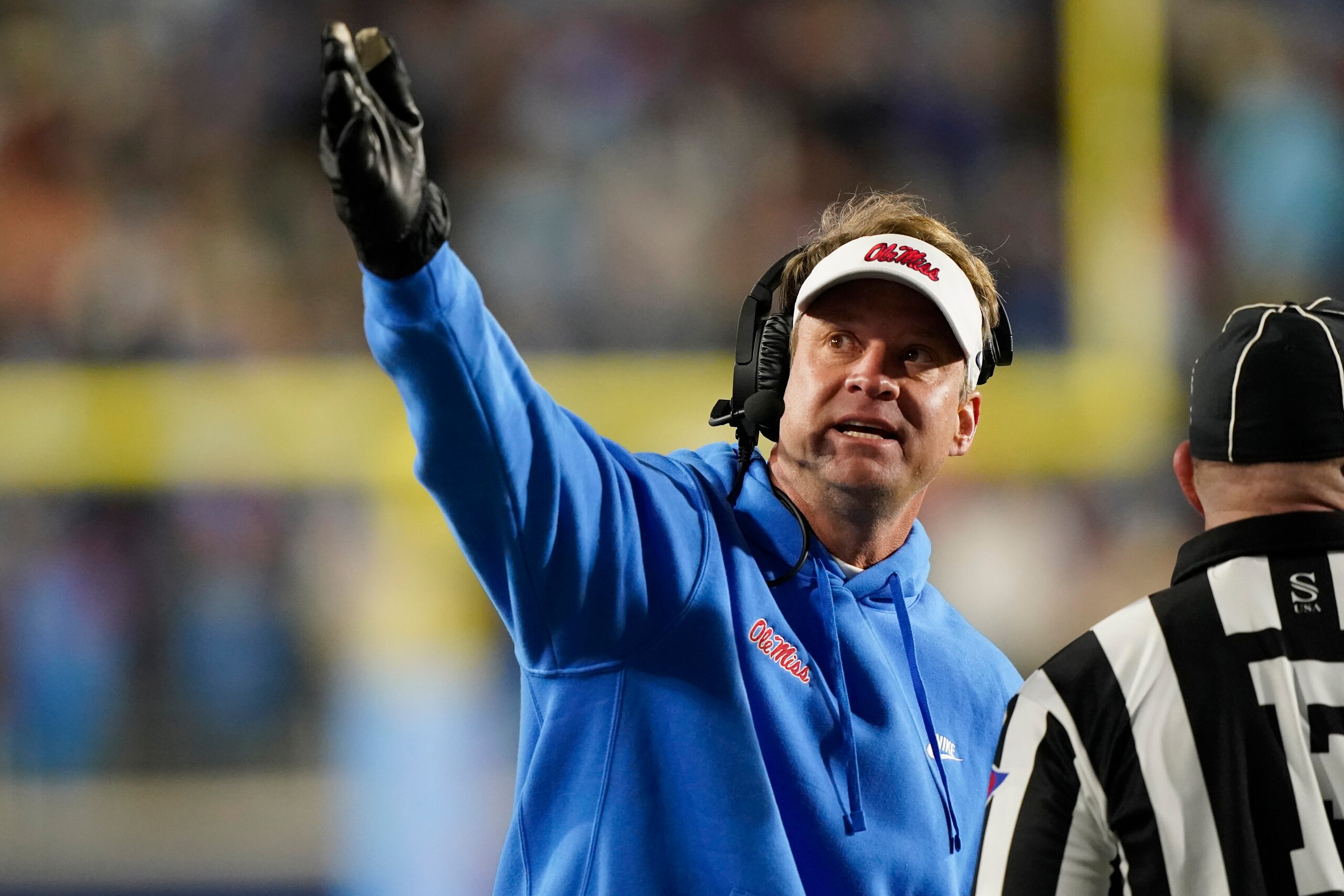 Mississippi head coach Lane Kiffin argues a call, that is shown on the stadium monitor, with a field official during the second half of an NCAA college football game against Texas A&M, Saturday, Nov. 13, 2021, in Oxford, Miss. Mississippi won 29-19. (AP Photo/Rogelio V. Solis)