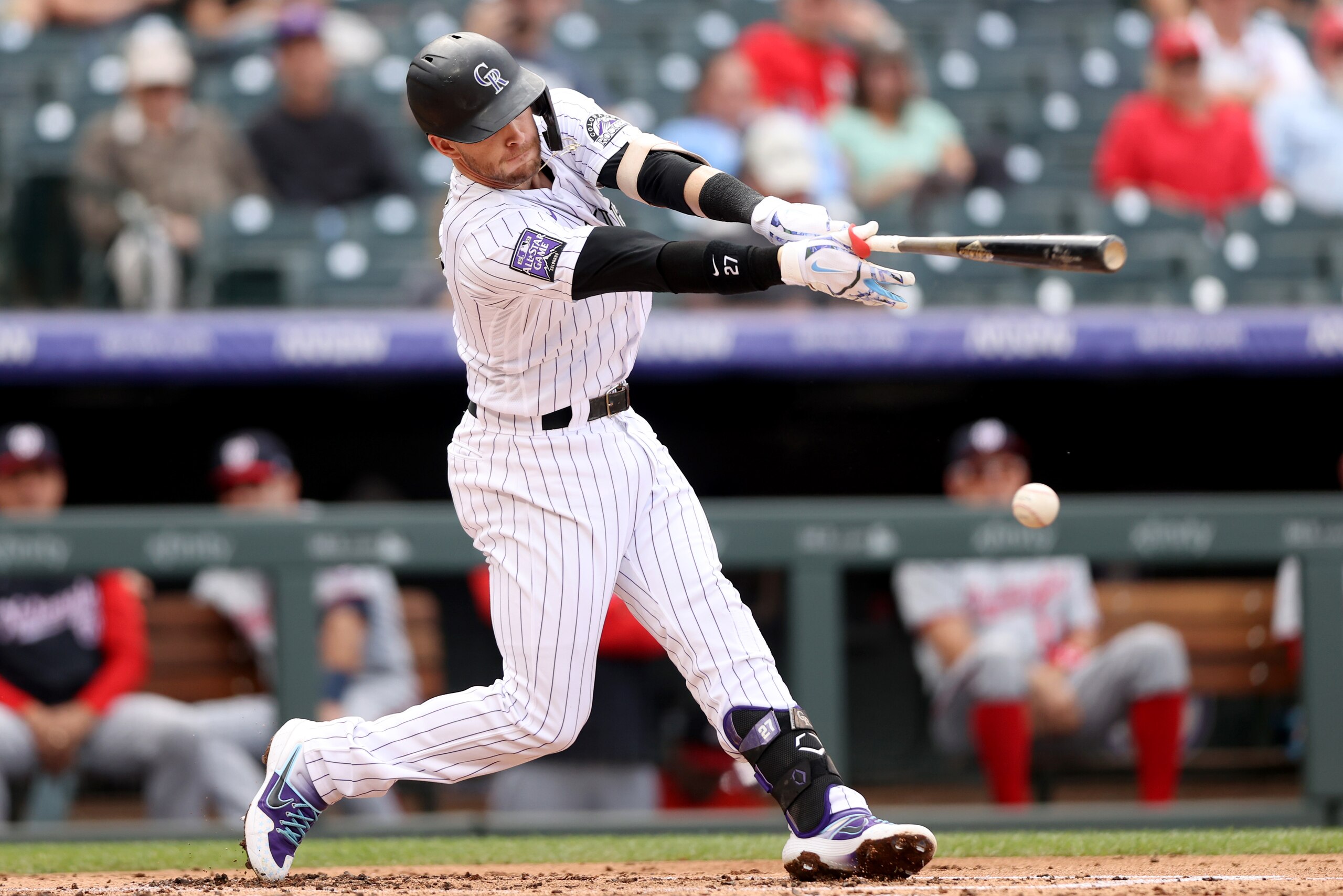 DENVER, COLORADO - SEPTEMBER 29: Trevor Story #27 of the Colorado Rockies hits a single against the Washington Nationals in the first inning at Coors Field on September 29, 2021 in Denver, Colorado. (Photo by Matthew Stockman/Getty Images)