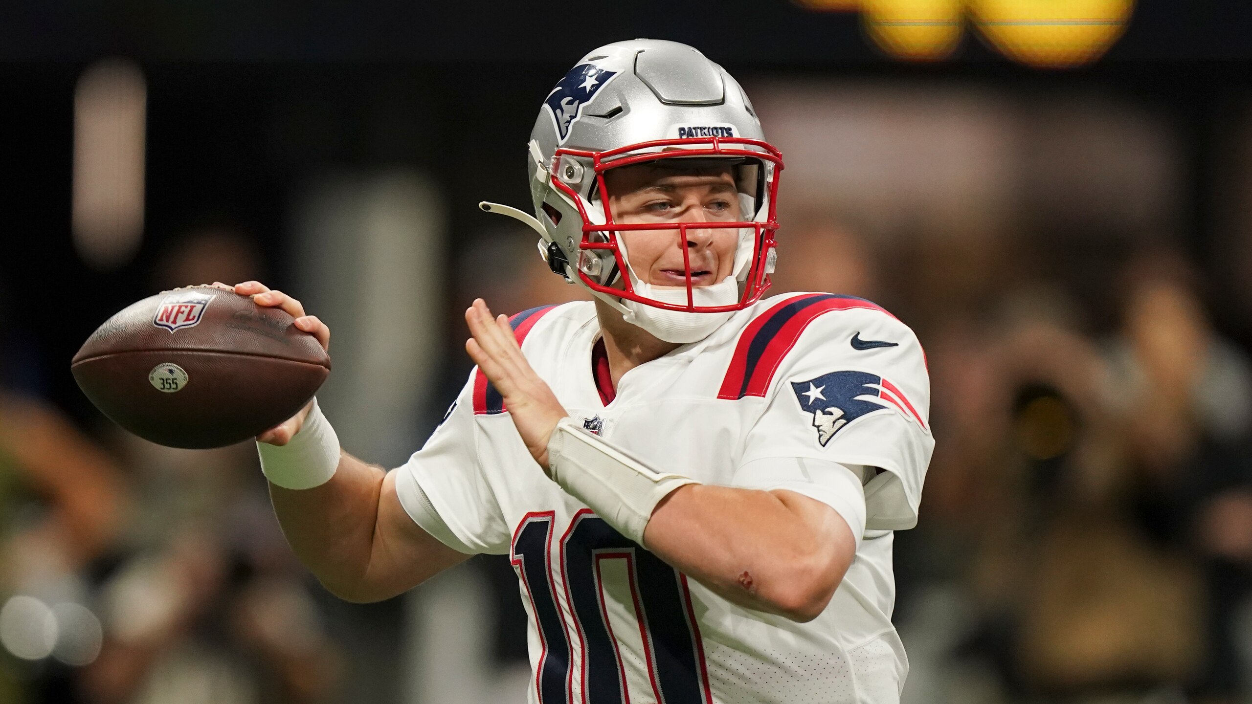 New England Patriots quarterback Mac Jones (10) works against the Atlanta Falcons during the first half of an NFL football game, Thursday, Nov. 18, 2021, in Atlanta. (AP Photo/Brynn Anderson)