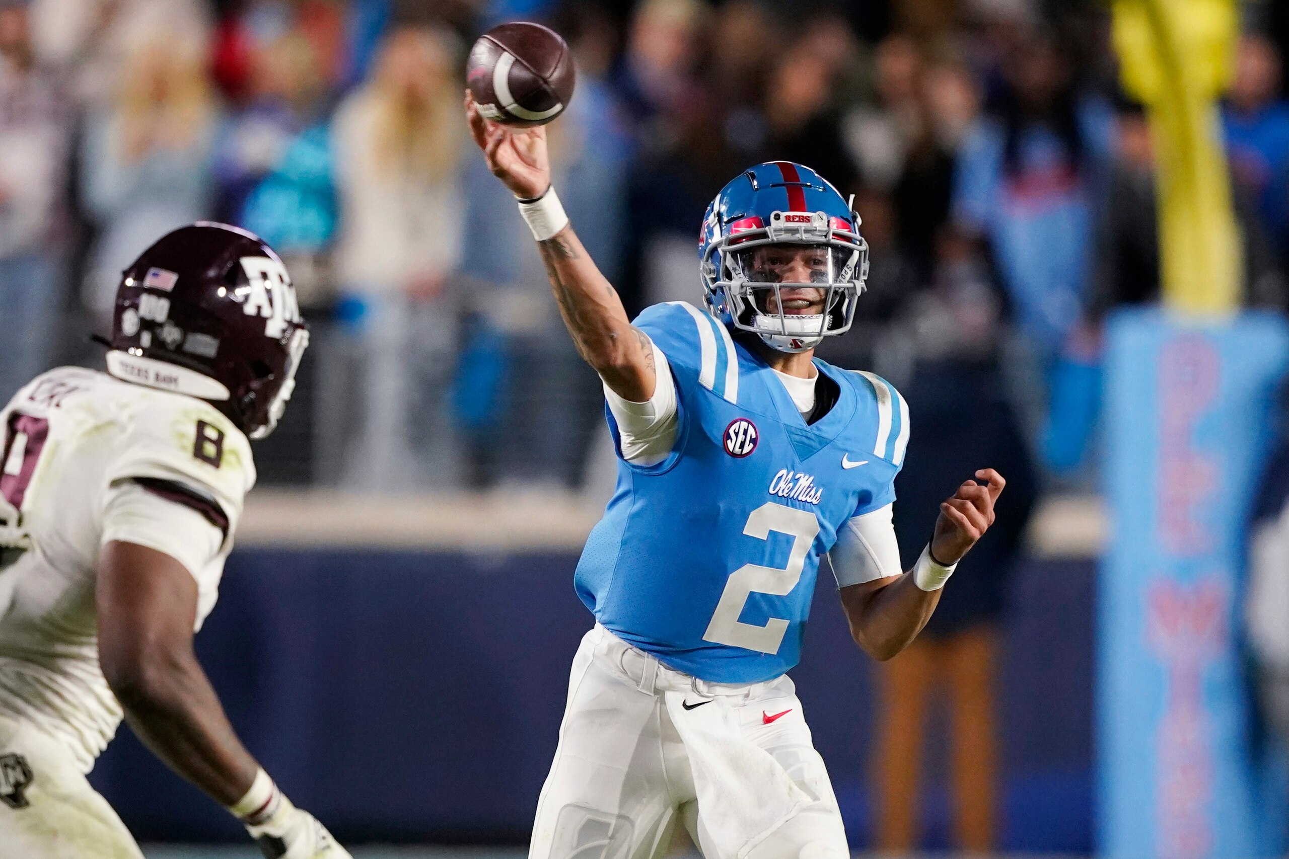 Mississippi quarterback Matt Corral throws a pass as Texas A&M defensive lineman DeMarvin Leal (8) defends during the second half of an NCAA college football game, Saturday, Nov. 13, 2021, in Oxford, Miss. (AP Photo/Rogelio V. Solis)