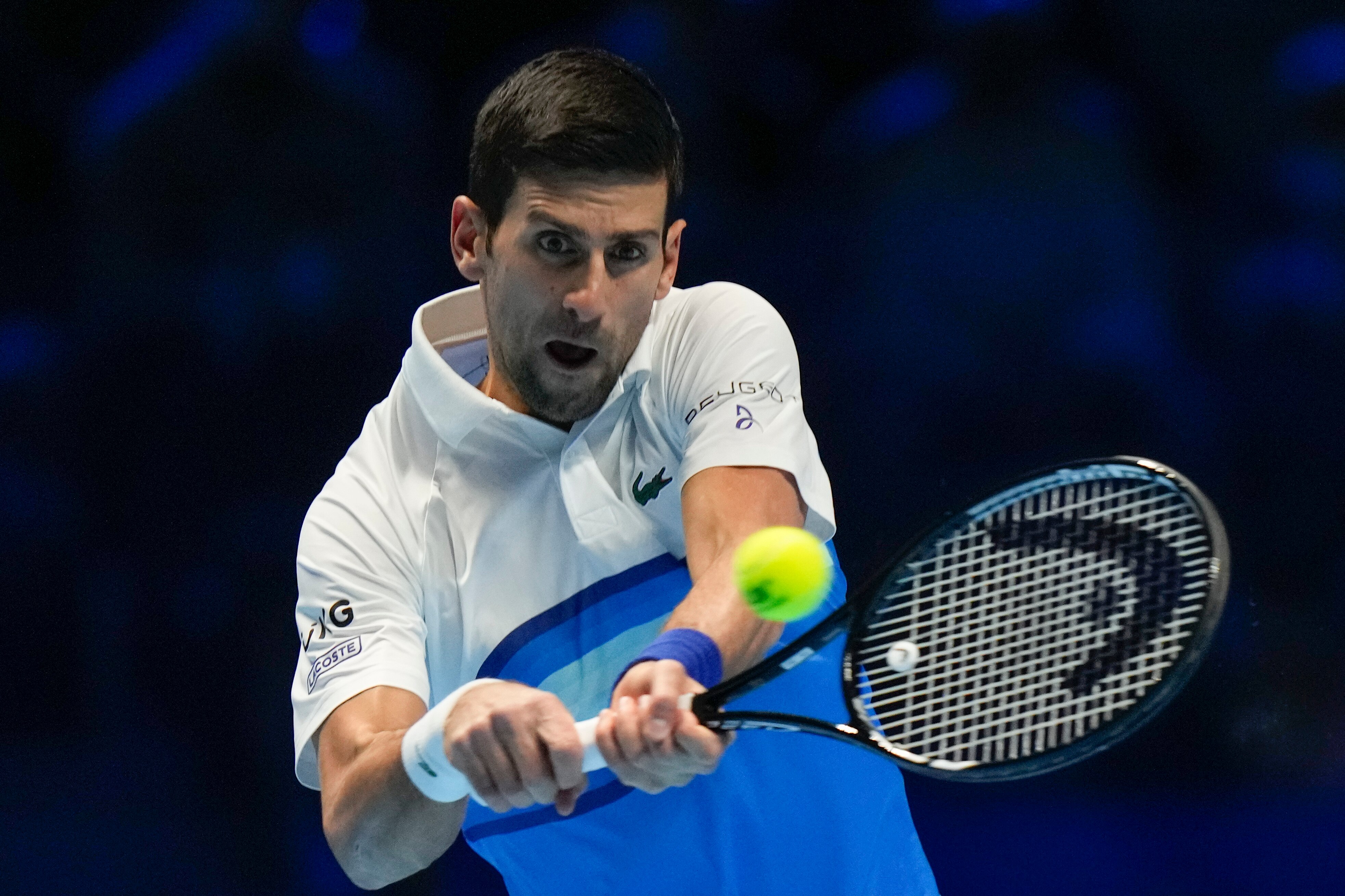 Serbia's Novak Djokovic returns the ball to Britain's Cameron Norrie during their ATP World Tour Finals singles tennis match, at the Pala Alpitour in Turin, Friday, Nov. 19, 2021. (AP Photo/Luca Bruno)