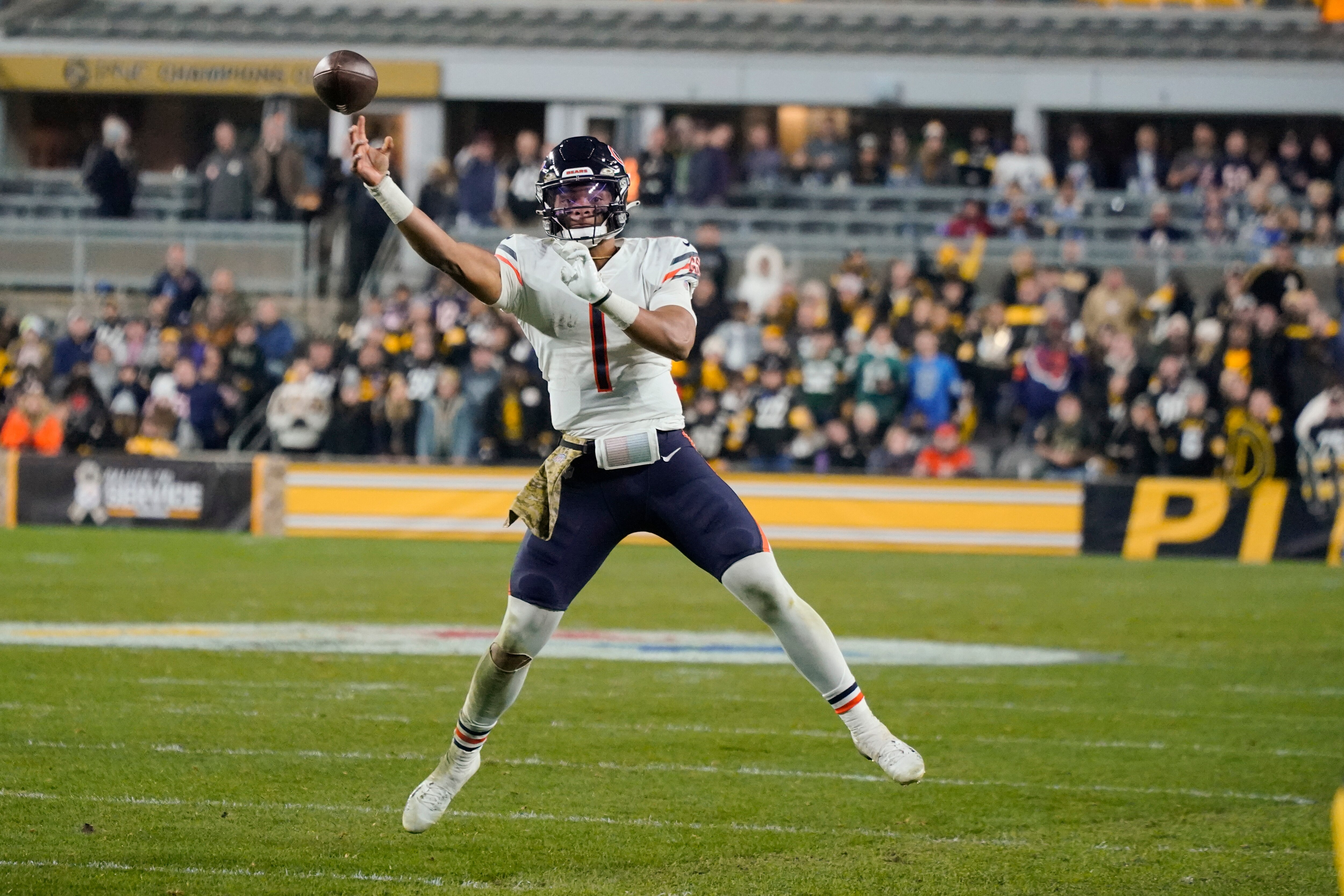 Chicago Bears quarterback Justin Fields (1) passes as he scrambles during the second half of an NFL football game, Monday, Nov. 8, 2021, in Pittsburgh. (AP Photo/Gene J. Puskar)
