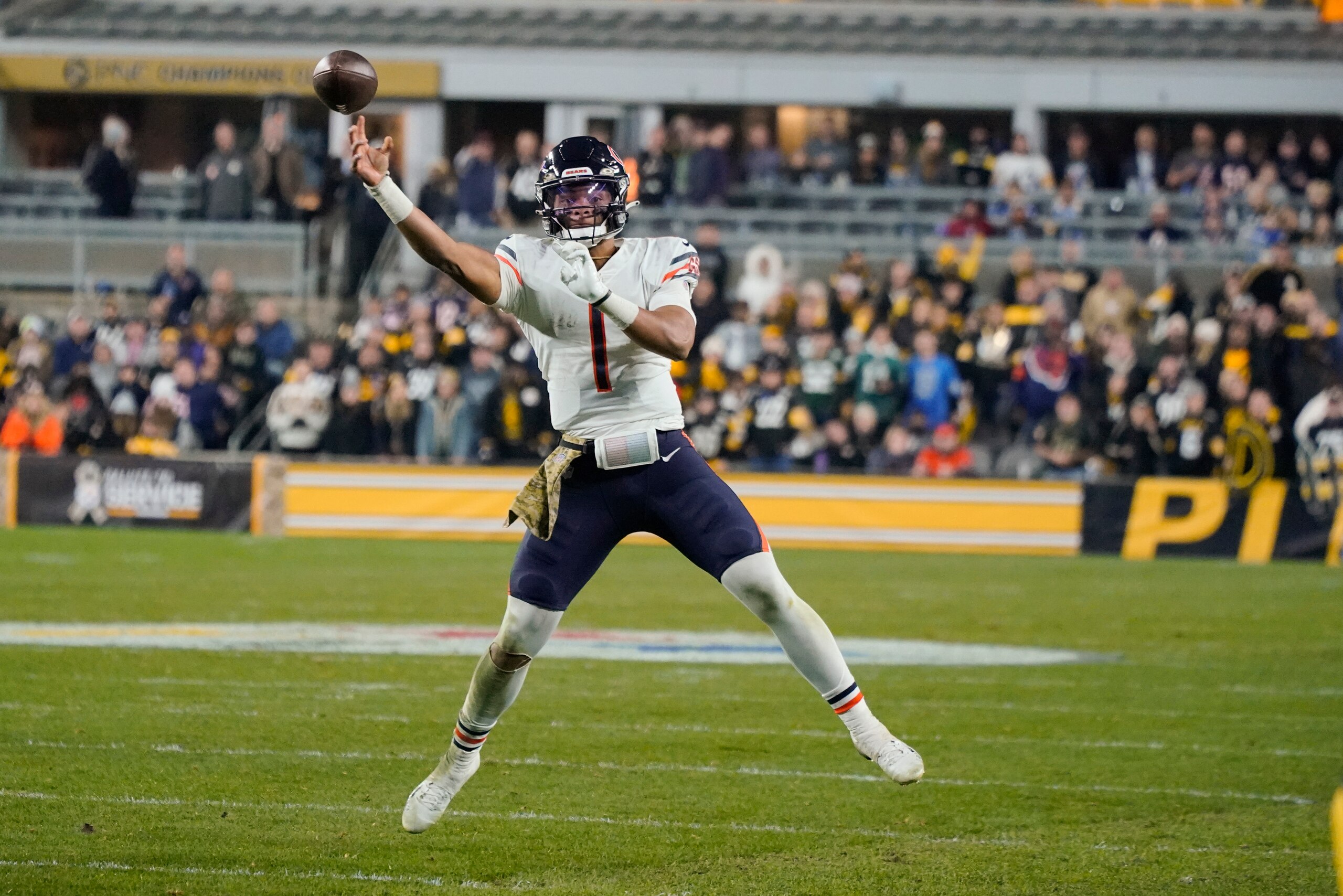 Chicago Bears quarterback Justin Fields (1) passes as he scrambles during the second half of an NFL football game, Monday, Nov. 8, 2021, in Pittsburgh. (AP Photo/Gene J. Puskar)