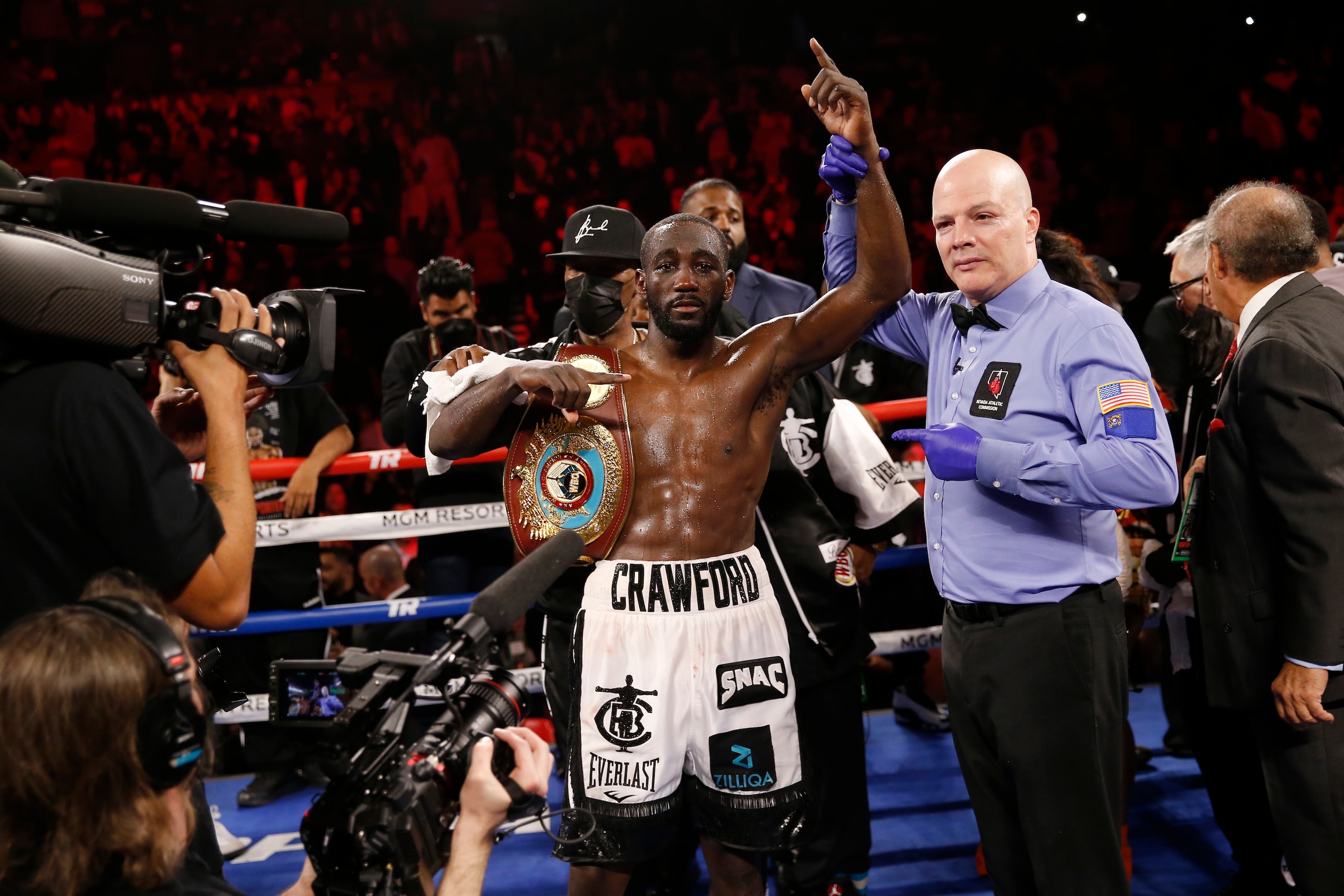 Terence Crawford poses for photographers after defeating Shawn Porter by TKO in a welterweight title boxing match Saturday, Nov. 20, 2021, in Las Vegas. (AP Photo/Chase Stevens)