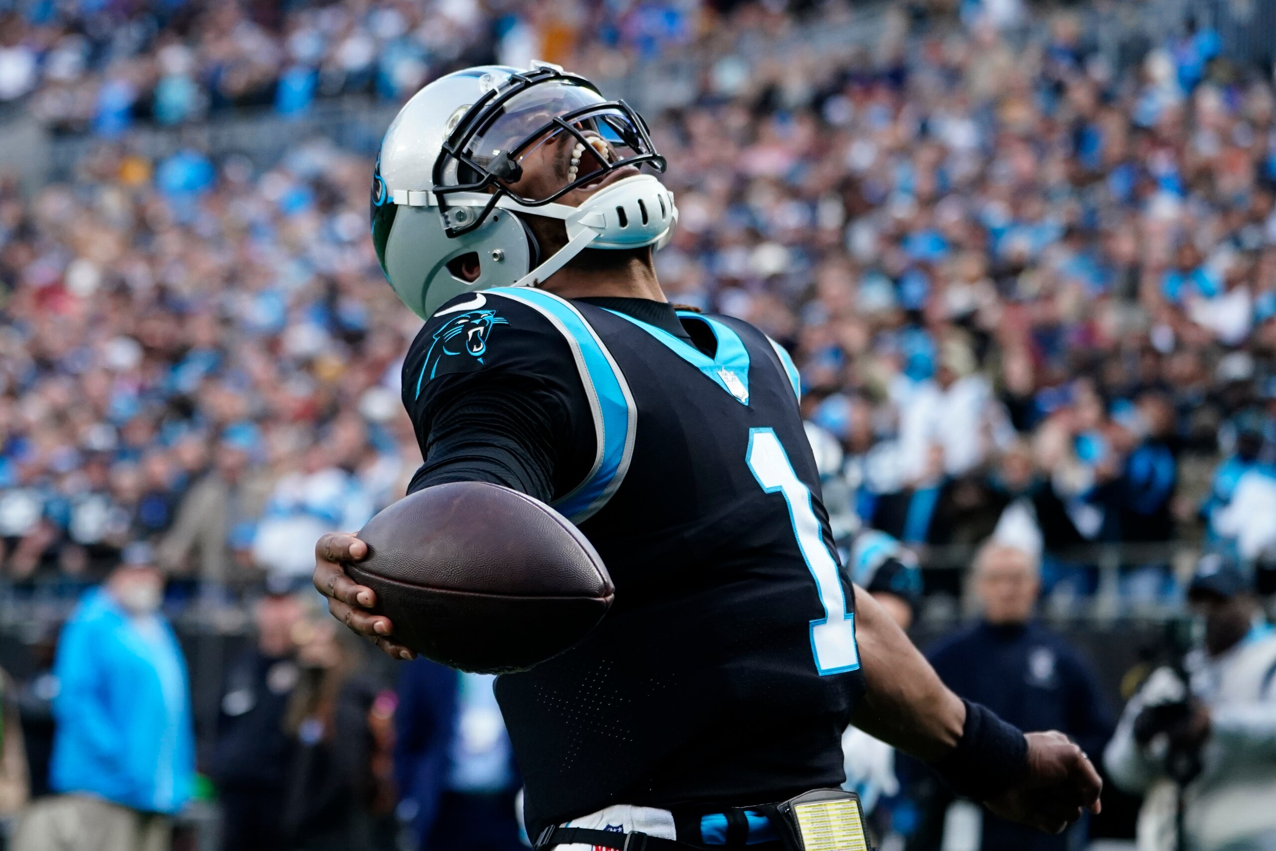 Carolina Panthers quarterback Cam Newton celebrates hit touchdown pass to running back Christian McCaffrey during the second half of an NFL football game against the Washington Football Team Sunday, Nov. 21, 2021, in Charlotte, N.C. (AP Photo/Jacob Kupferman)