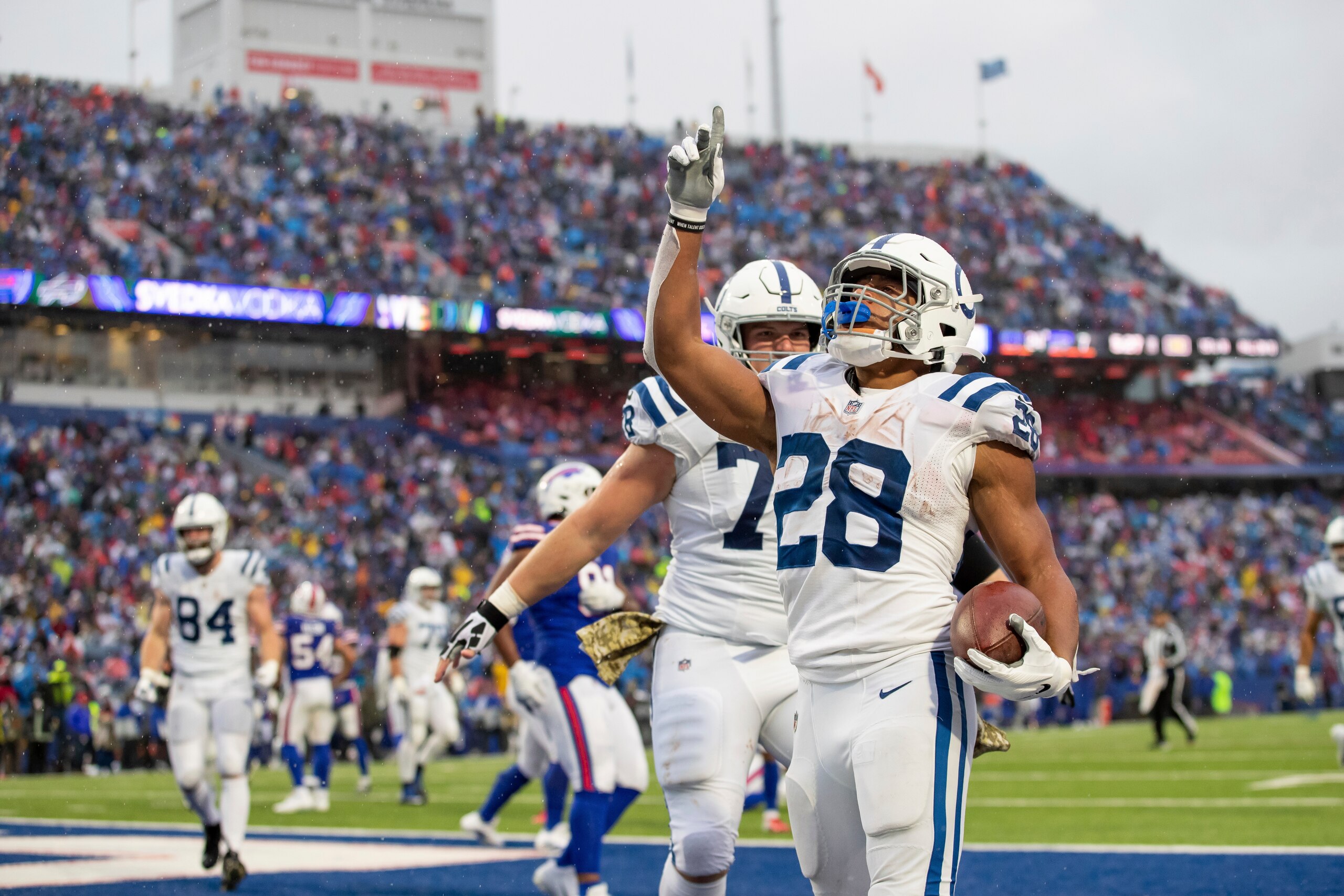 Running back (28) Jonathan Taylor of the Indianapolis Colts celebrates after scoring a touchdown against the Buffalo Bills in an NFL football game, Sunday, Nov. 21, 2021, in Orchard Park, NY. The Colts defeated the Bills 41-15. (AP Photo/Jeff Lewis)
