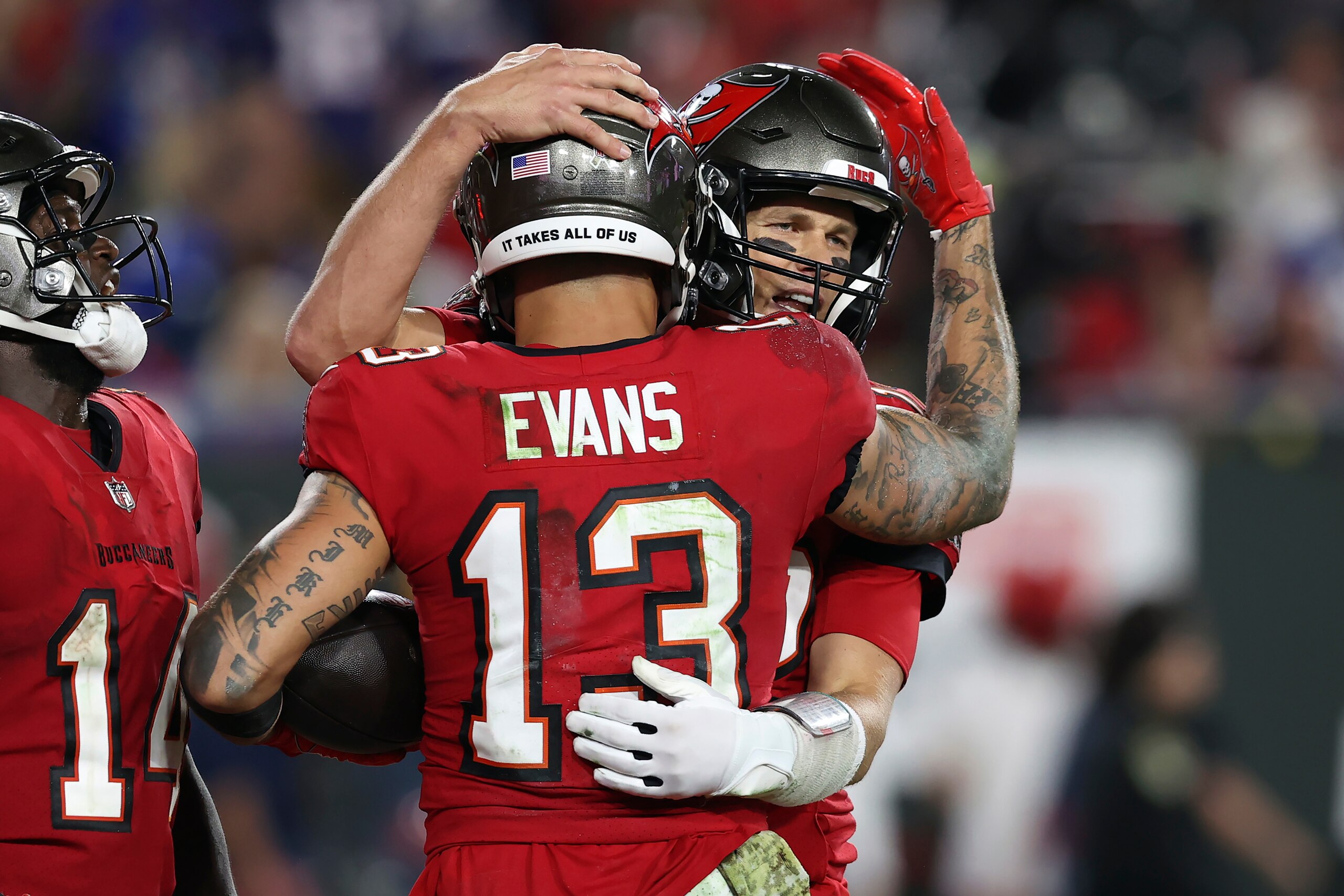 Tampa Bay Buccaneers wide receiver Mike Evans (13) hugs quarterback Tom Brady (12) after Evans caught a 5-yard touchdown pass during the second half of an NFL football game against the New York Giants Monday, Nov. 22, 2021, in Tampa, Fla. (AP Photo/Mark LoMoglio)
