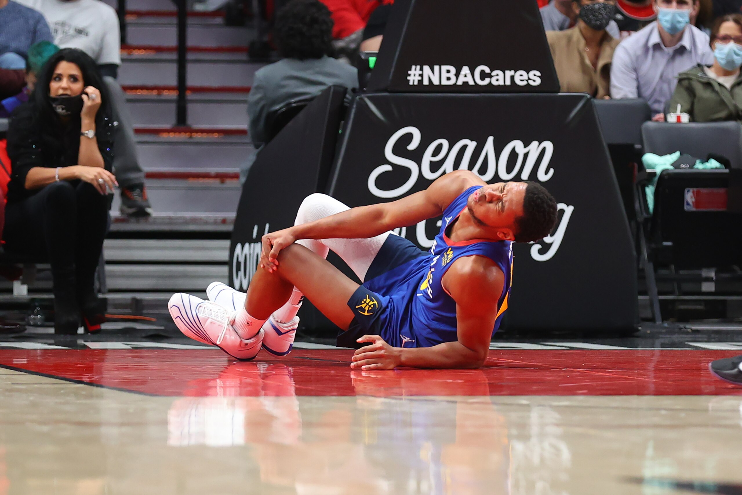 PORTLAND, OREGON - NOVEMBER 23: P.J. Dozier #35 of the Denver Nuggets reacts after sustaining an injury during the first half against the Portland Trail Blazers at Moda Center on November 23, 2021 in Portland, Oregon. NOTE TO USER: User expressly acknowledges and agrees that, by downloading and or using this photograph, User is consenting to the terms and conditions of the Getty Images License Agreement.  (Photo by Abbie Parr/Getty Images)