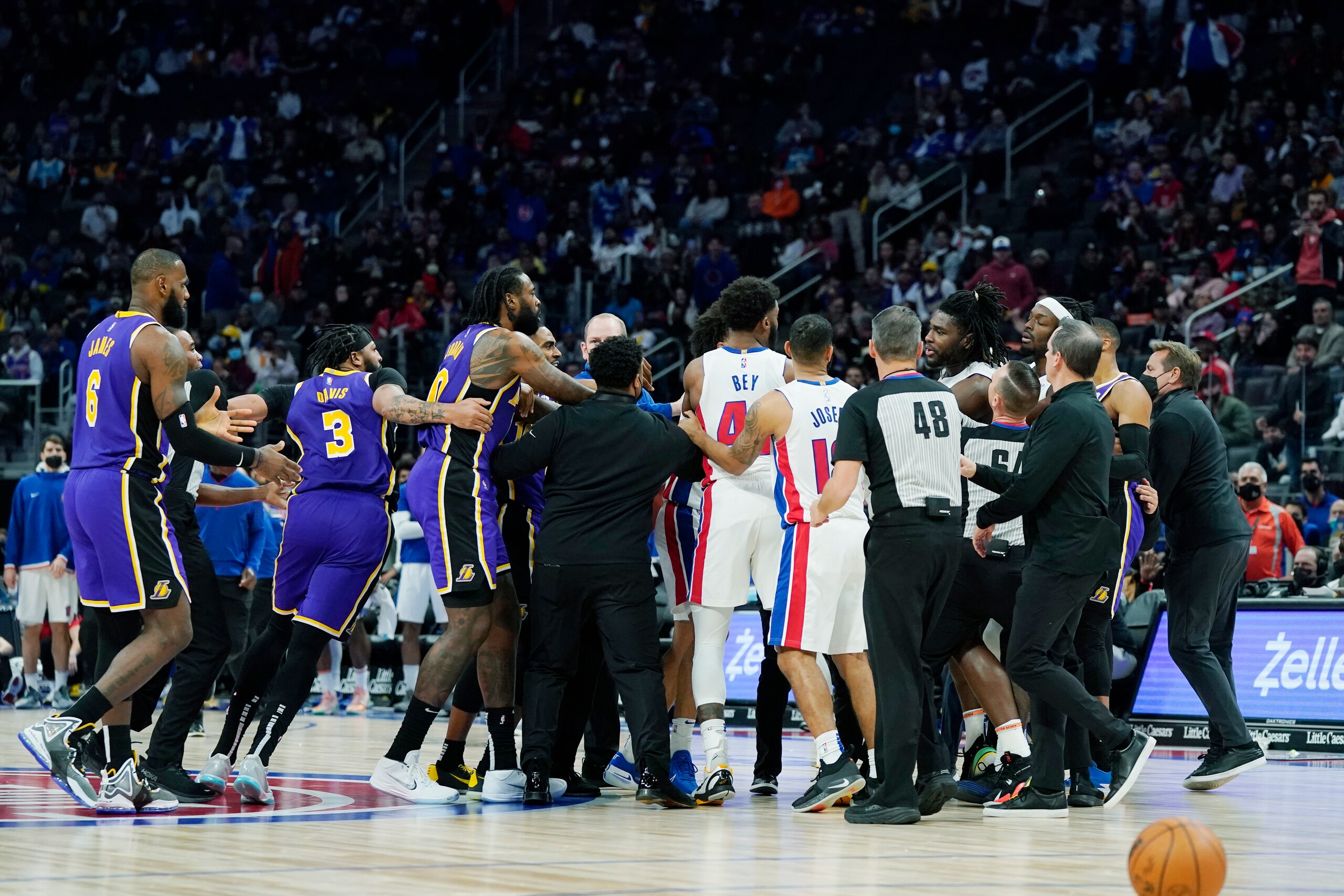 Players separate Los Angeles Lakers forward LeBron James, left, and Detroit Pistons center Isaiah Stewart, far right center, during the second half of an NBA basketball game, Sunday, Nov. 21, 2021, in Detroit. (AP Photo/Carlos Osorio)