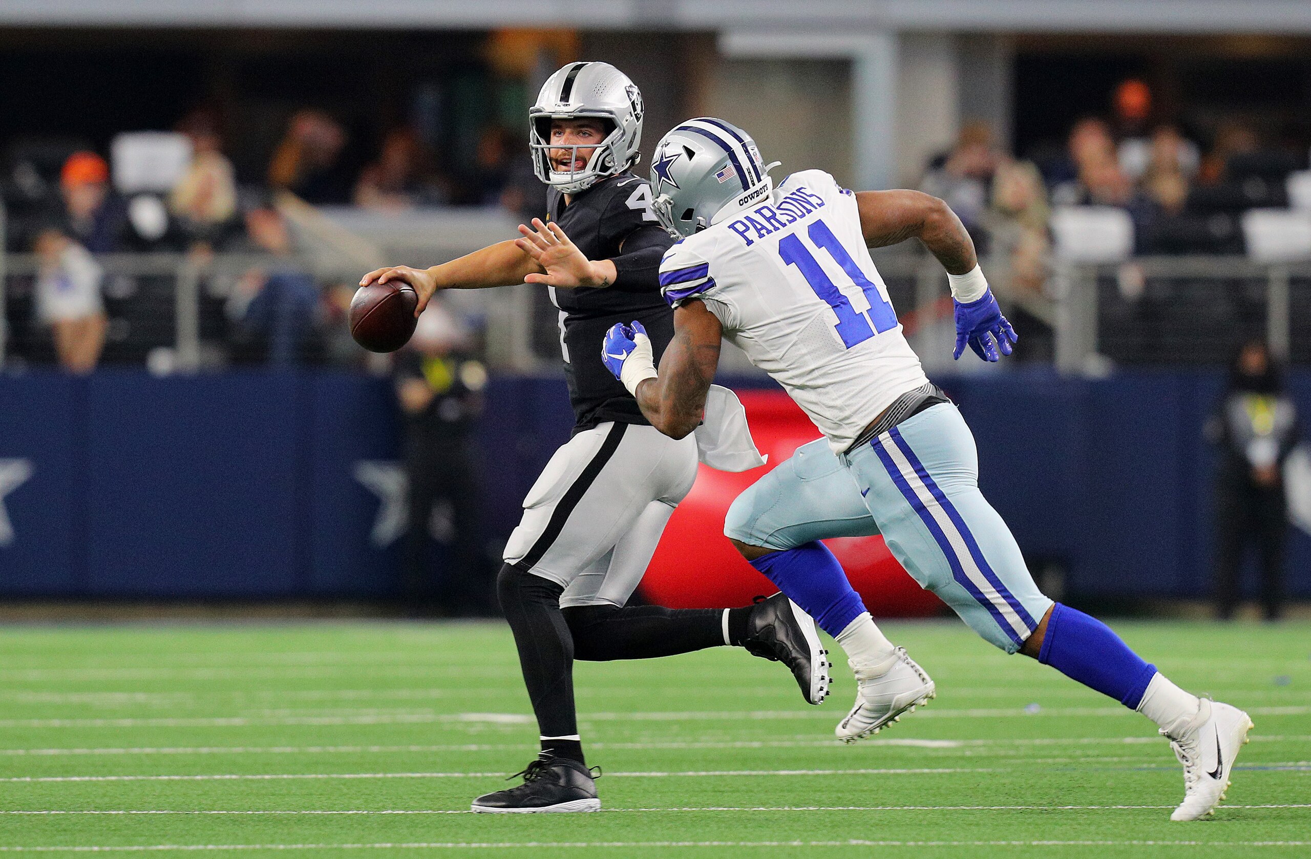 ARLINGTON, TEXAS - NOVEMBER 25: Derek Carr #4 of the Las Vegas Raiders throws the ball under pressure from Micah Parsons #11 of the Dallas Cowboys during the first quarter of the NFL game at AT&T Stadium on November 25, 2021 in Arlington, Texas. (Photo by Richard Rodriguez/Getty Images)
