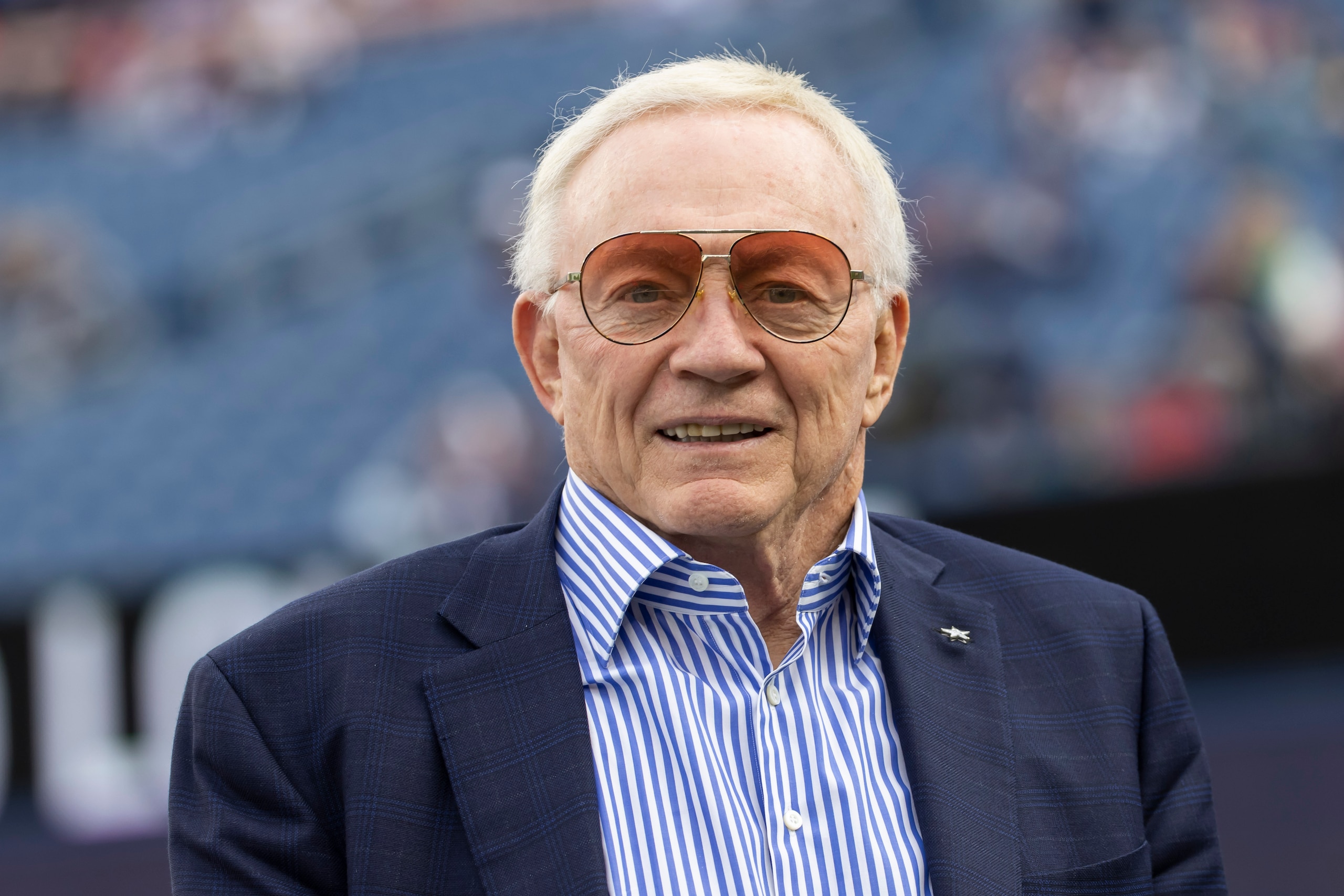 Dallas Cowboys owner Jerry Jones walks onto the field prior to an NFL football game against the New England Patriots, Sunday, Oct. 17, 2021, in Foxborough, Mass. (AP Photo/Greg M. Cooper)