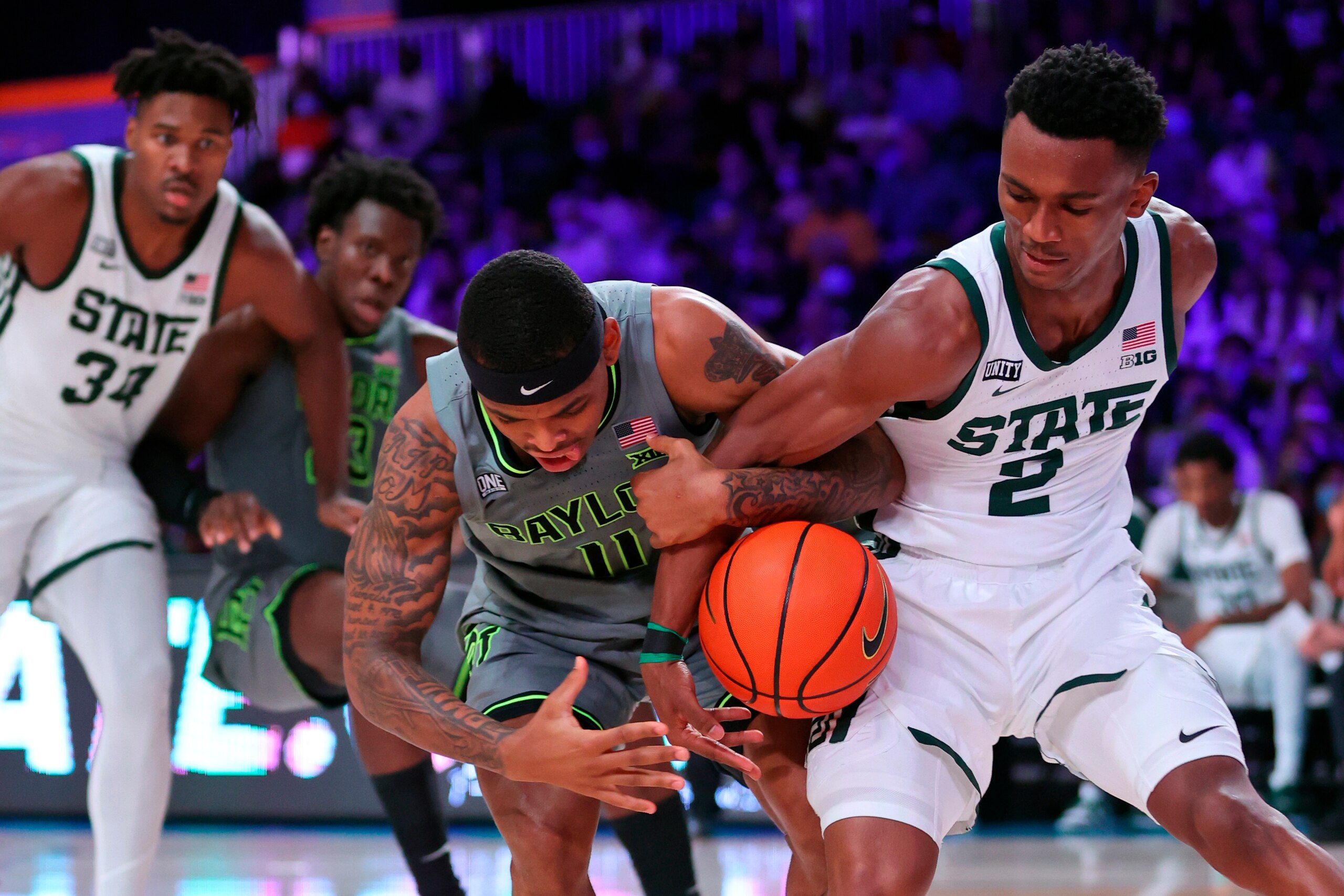 In this photo provided by Bahamas Visual Services, Baylor guard James Akinjo (11) and Michigan State guard Tyson Walker (2) battle for the ball  during an NCAA college basketball game at Paradise Island, Bahamas, Friday, Nov. 26, 2021. (Tim Aylen/Bahamas Visual Services via AP)