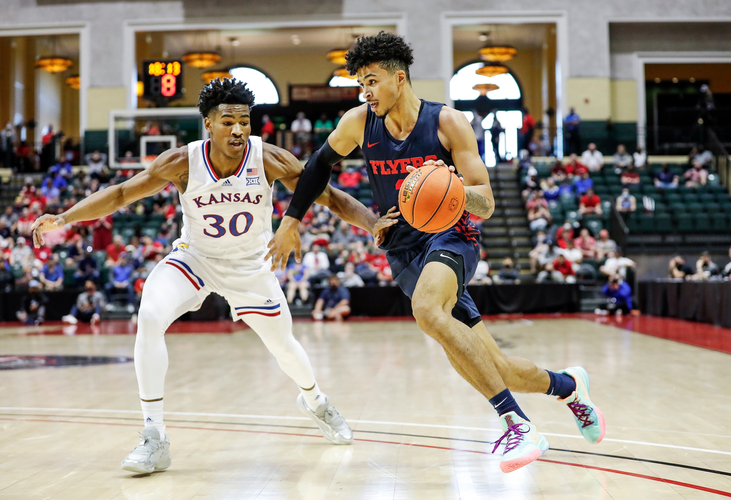 Kansas guard Ochai Agbaji defends as Dayton forward Toumani Camara, right, drives during the first half of an NCAA college basketball game Friday, Nov. 26, 2021, in Lake Buena Vista, Fla. (AP Photo/Jacob M. Langston)