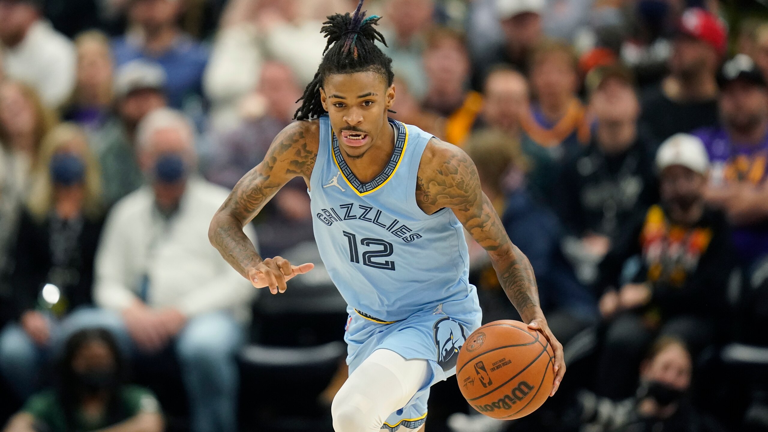 Memphis Grizzlies guard Ja Morant (12) brings the ball up court in the second half during an NBA basketball game against the Utah Jazz Monday, Nov. 22, 2021, in Salt Lake City. (AP Photo/Rick Bowmer)