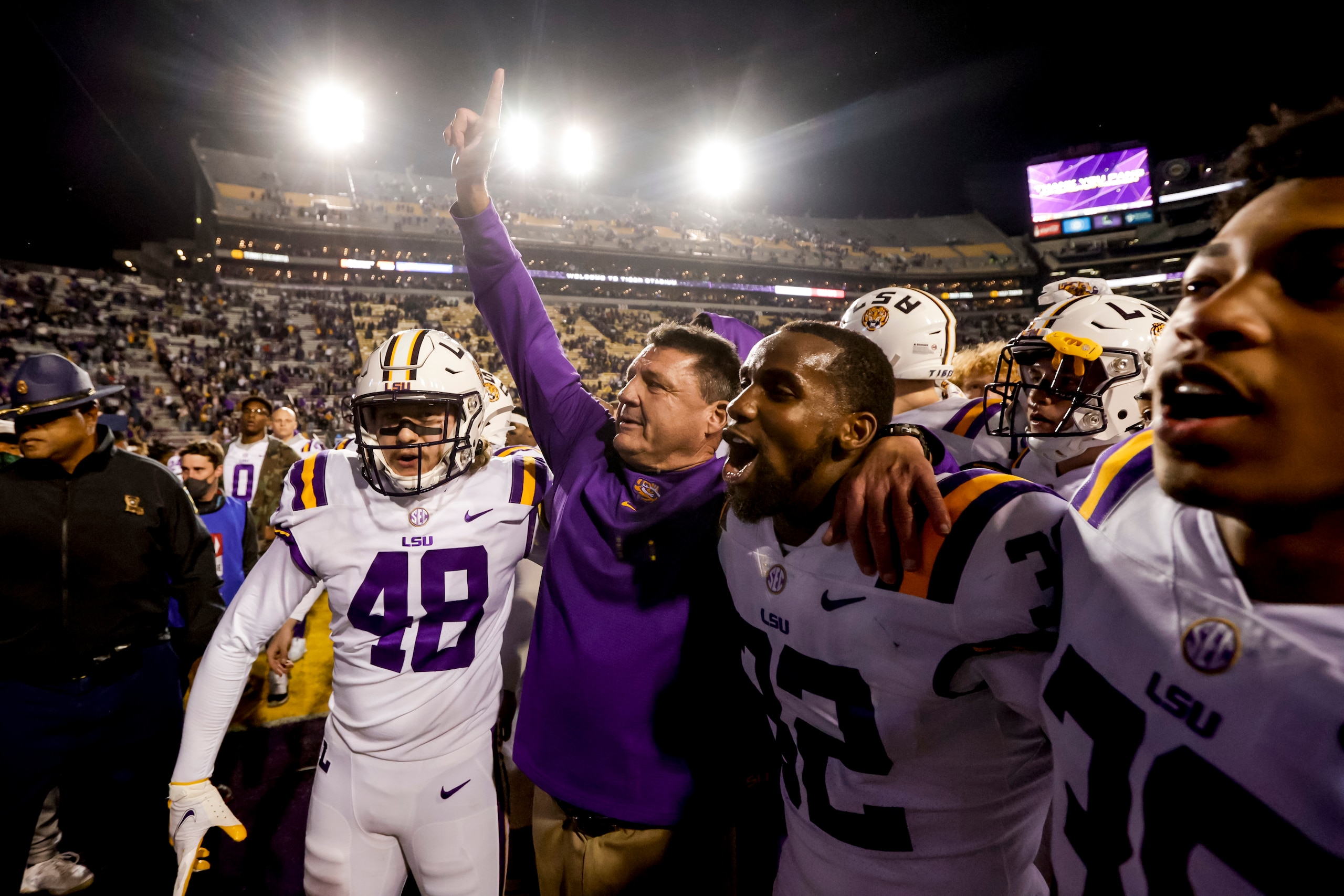 LSU head coach Ed Orgeron, center, celebrates with linebacker Sloan Wright (48) and cornerback Lloyd Cole (32) following a win over Texas A&M in an NCAA college football game in Baton Rouge, La., Saturday, Nov. 27, 2021. (AP Photo/Derick Hingle)