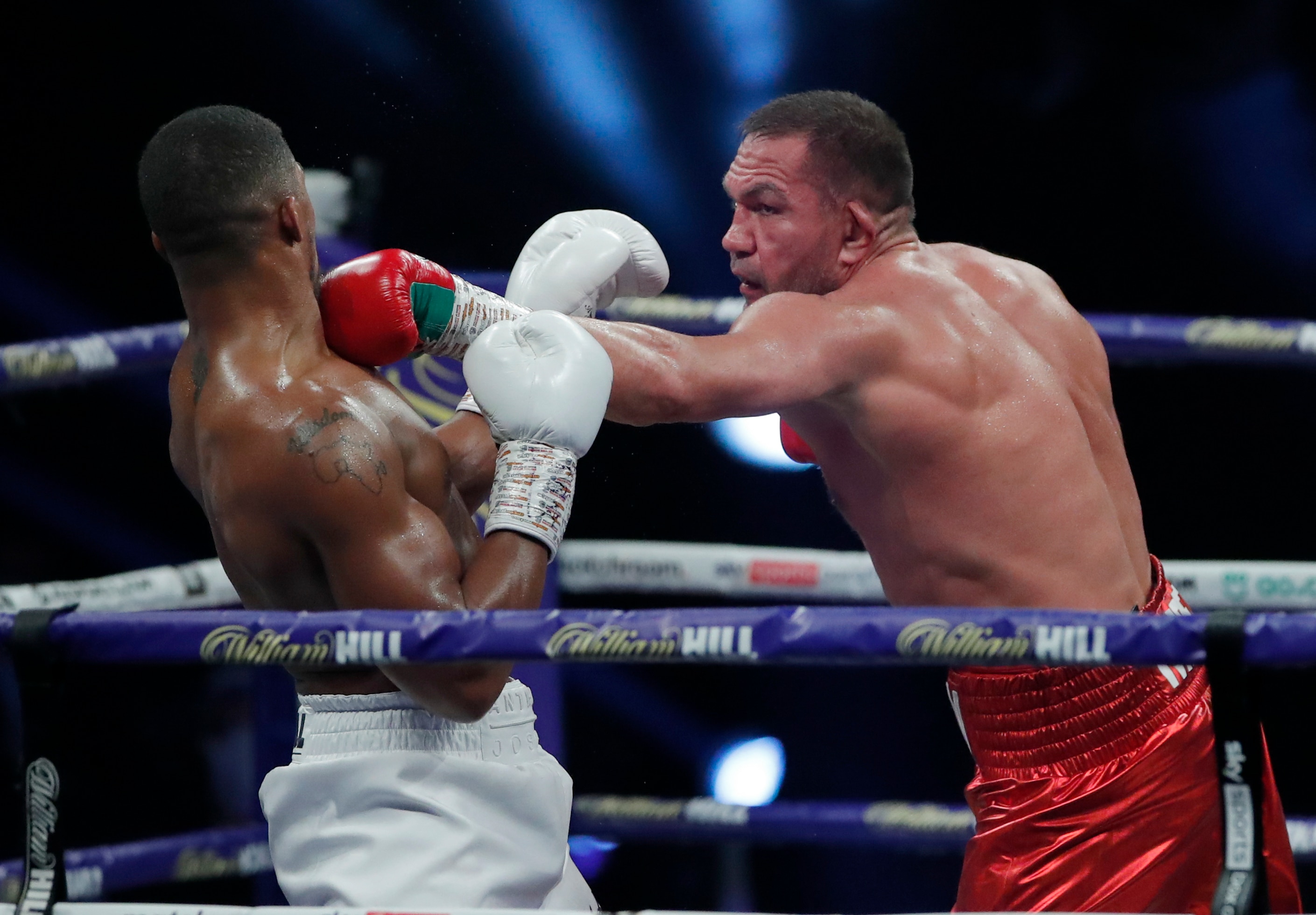 World Heavyweight boxing champion Britain's Anthony Joshua, left, sways back from a punch by challenger Bulgaria's Kubrat Pulev during their Heavyweight title fight at Wembley Arena in London Saturday, Dec. 12, 2020. (Andrew Couldridge/Pool via AP)