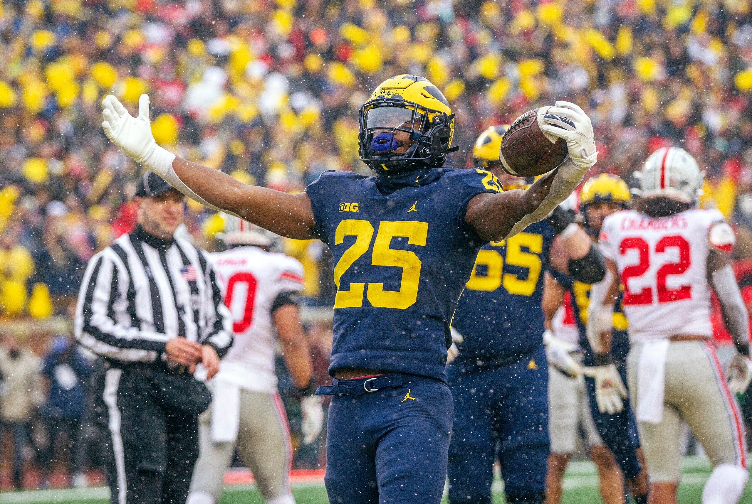 Michigan running back Hassan Haskins (25) celebrates a touchdown in the fourth quarter of an NCAA college football game against Ohio State in Ann Arbor, Mich., Saturday, Nov. 27, 2021. Michigan won 42-27. (AP Photo/Tony Ding)