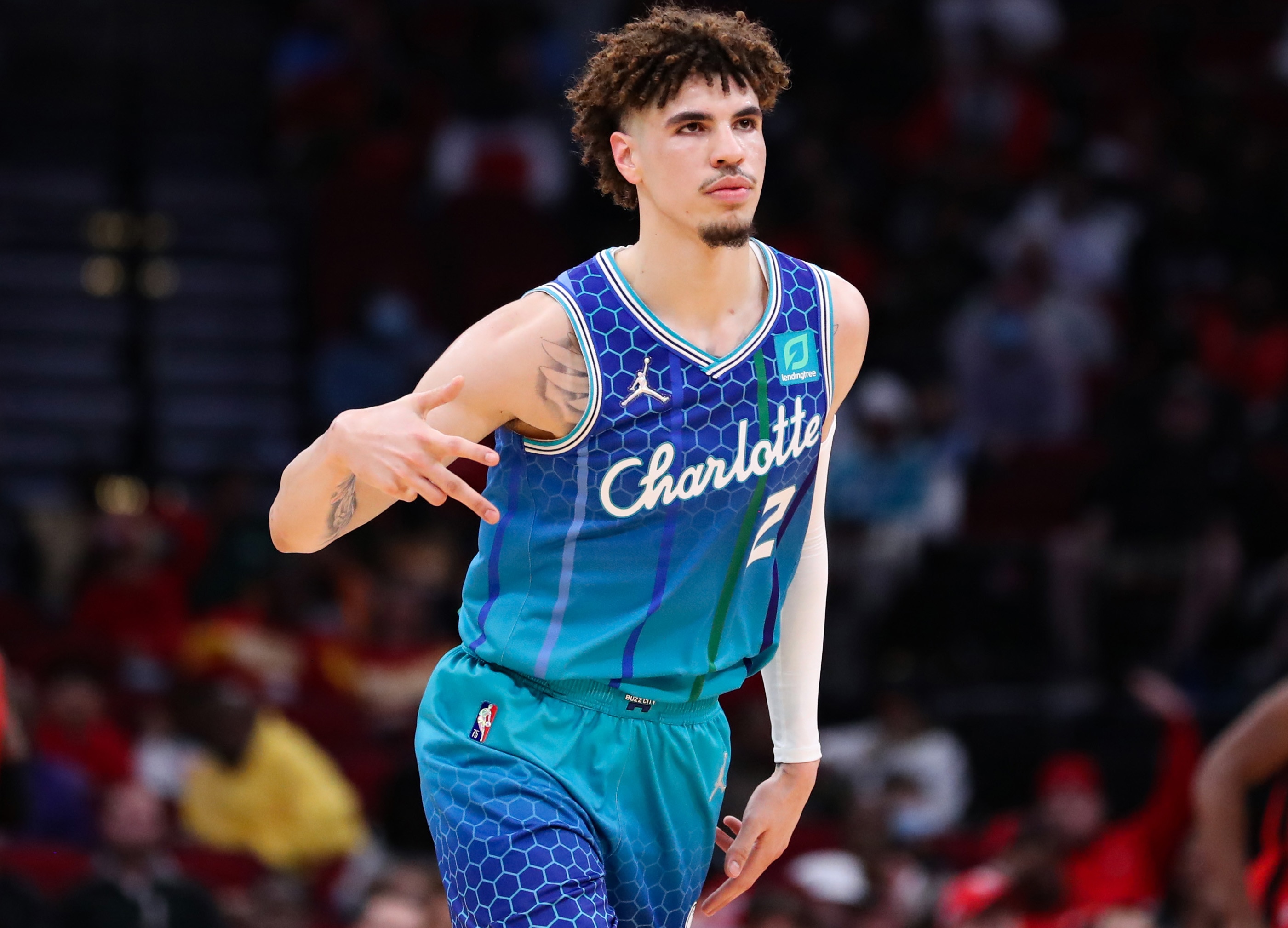 HOUSTON, TEXAS - NOVEMBER 27: LaMelo Ball #2 of the Charlotte Hornets reacts to a three point basket during the first half against the Houston Rockets at Toyota Center on November 27, 2021 in Houston, Texas. NOTE TO USER: User expressly acknowledges and agrees that, by downloading and or using this photograph, User is consenting to the terms and conditions of the Getty Images License Agreement. (Photo by Carmen Mandato/Getty Images)