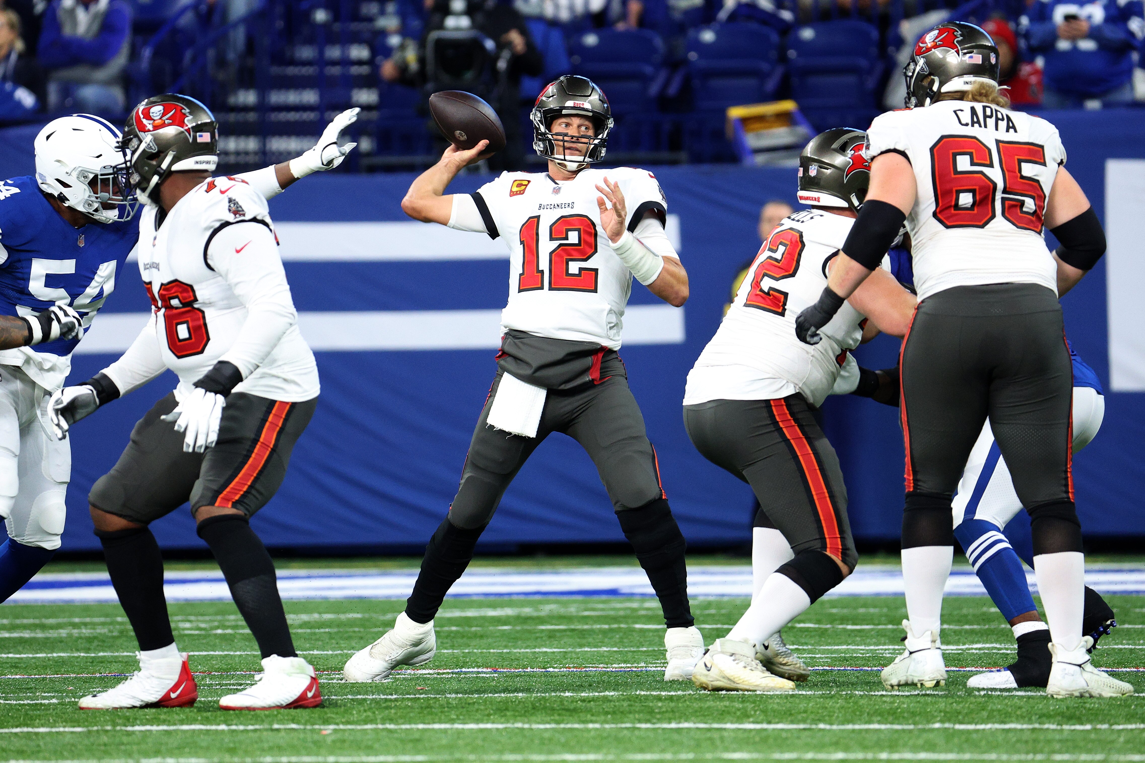 INDIANAPOLIS, INDIANA - NOVEMBER 28: Tom Brady #12 of the Tampa Bay Buccaneers looks for an open teammate in the first half of the game against the Indianapolis Colts at Lucas Oil Stadium on November 28, 2021 in Indianapolis, Indiana. (Photo by Andy Lyons/Getty Images)