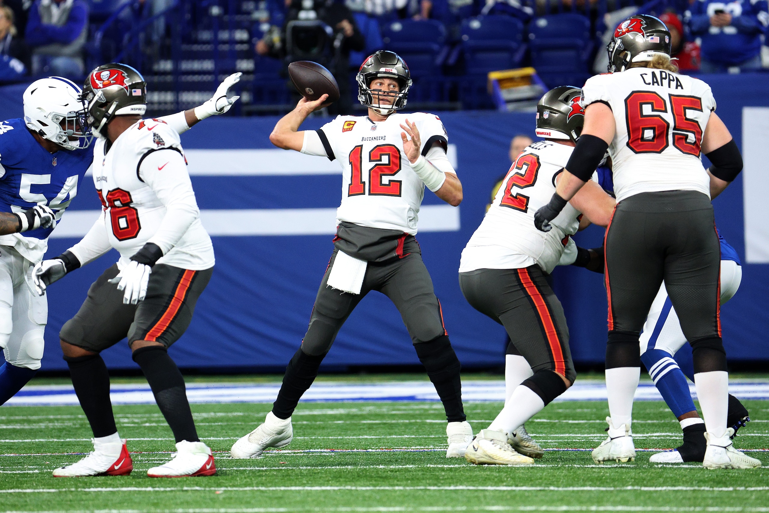 INDIANAPOLIS, INDIANA - NOVEMBER 28: Tom Brady #12 of the Tampa Bay Buccaneers looks for an open teammate in the first half of the game against the Indianapolis Colts at Lucas Oil Stadium on November 28, 2021 in Indianapolis, Indiana. (Photo by Andy Lyons/Getty Images)