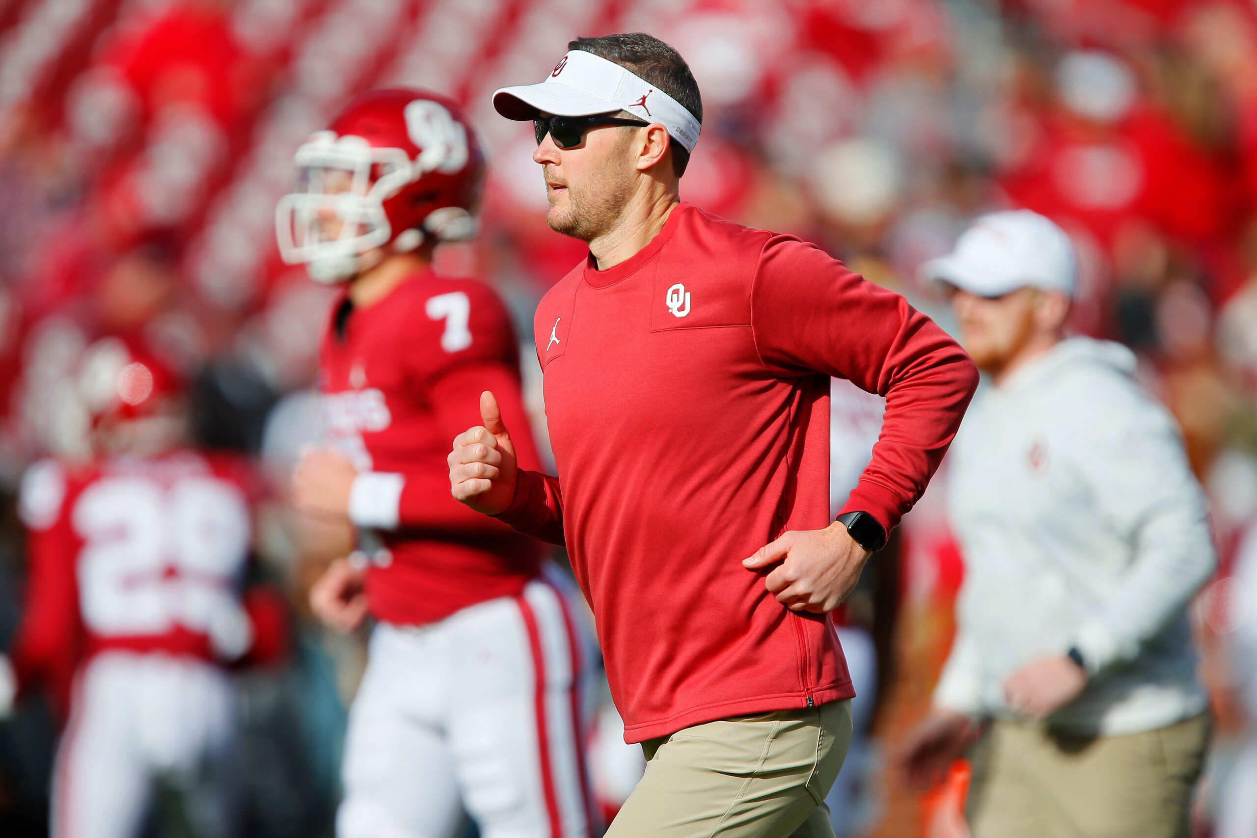 NORMAN, OK - NOVEMBER 20:  Head coach Lincoln Riley of the Oklahoma Sooners runs alongside quarterback Spencer Rattler #7 before a game against the Iowa State Cyclones at Gaylord Family Oklahoma Memorial Stadium on November 20, 2021 in Norman, Oklahoma.  The Sooners won 28-21.  (Photo by Brian Bahr/Getty Images)