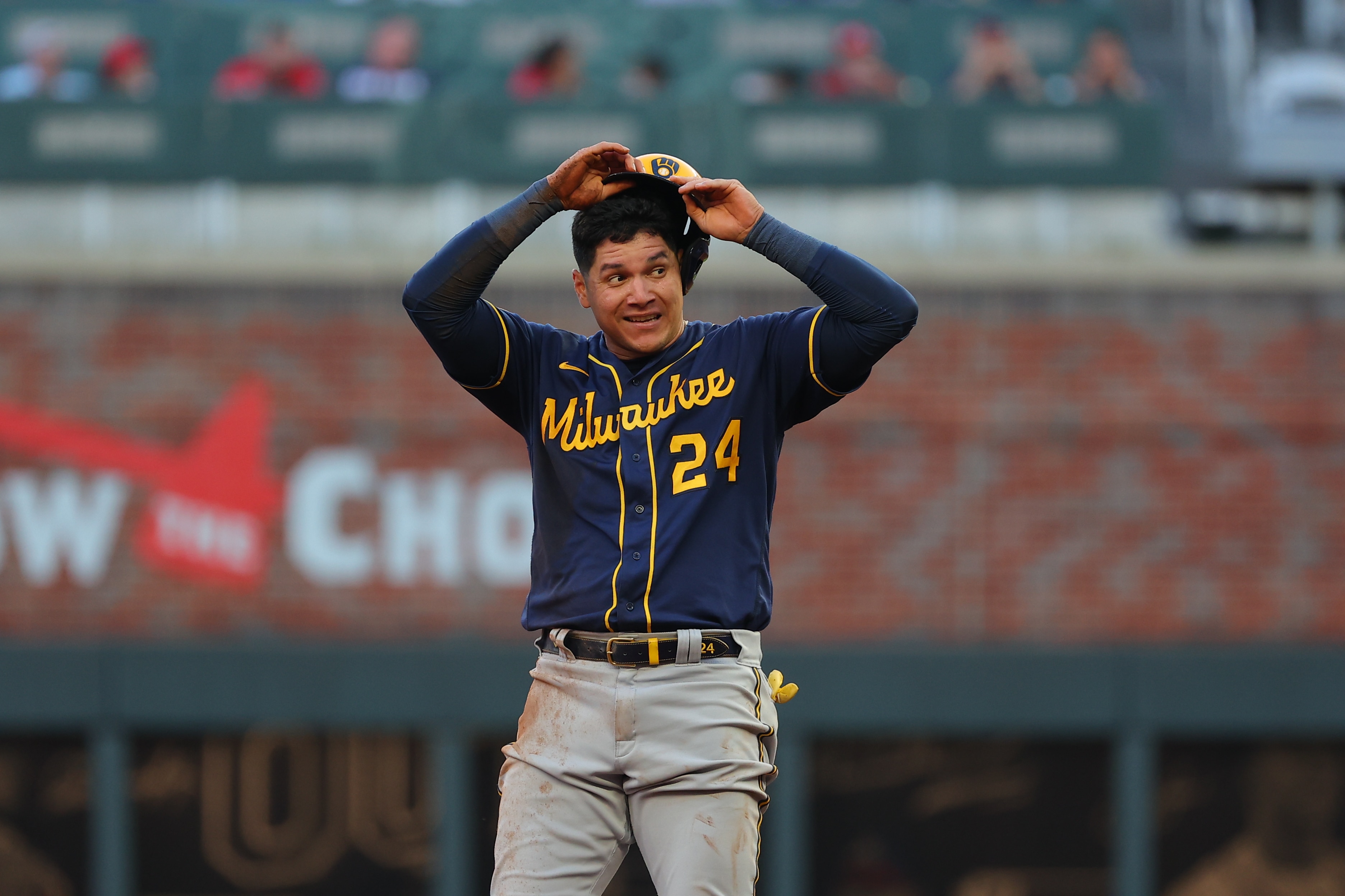 ATLANTA, GEORGIA - OCTOBER 12: Avisail Garcia #24 of the Milwaukee Brewers advances to second on a wild throw to first ahead of Dansby Swanson #7 of the Atlanta Braves during the fourth inning in game four of the National League Division Series at Truist Park on October 12, 2021 in Atlanta, Georgia. (Photo by Kevin C. Cox/Getty Images)
