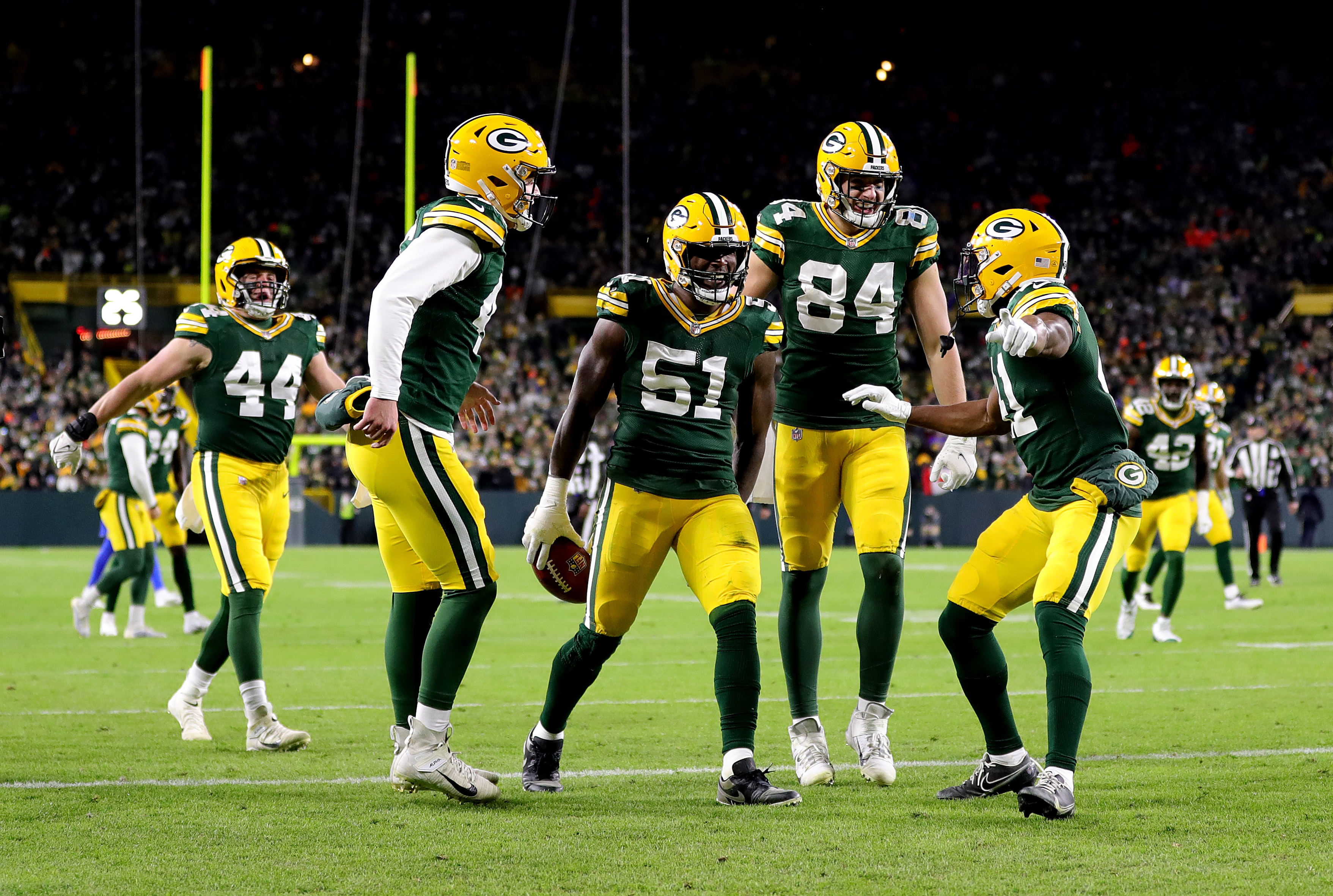 GREEN BAY, WISCONSIN - NOVEMBER 28: Krys Barnes #51 of the Green Bay Packers celebrates with teammates after recovering a fumbled punt catch by J.J. Koski #17 of the Los Angeles Rams (not pictured) during the third quarter at Lambeau Field on November 28, 2021 in Green Bay, Wisconsin. (Photo by Stacy Revere/Getty Images)