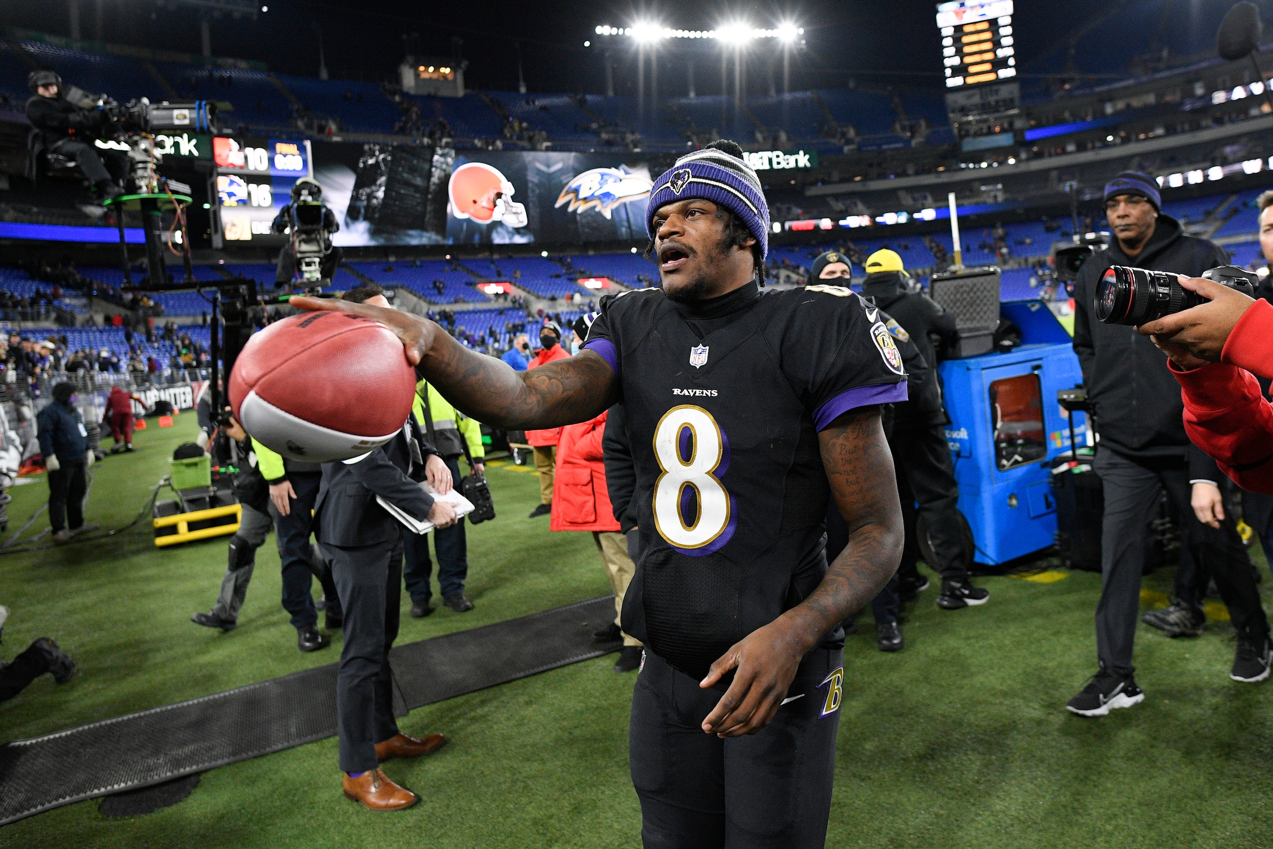Baltimore Ravens quarterback Lamar Jackson gifts a football to a young spectator at the end of an NFL football game against the Cleveland Browns, Sunday, Nov. 28, 2021, in Baltimore. The Ravens won 16-10. (AP Photo/Nick Wass)