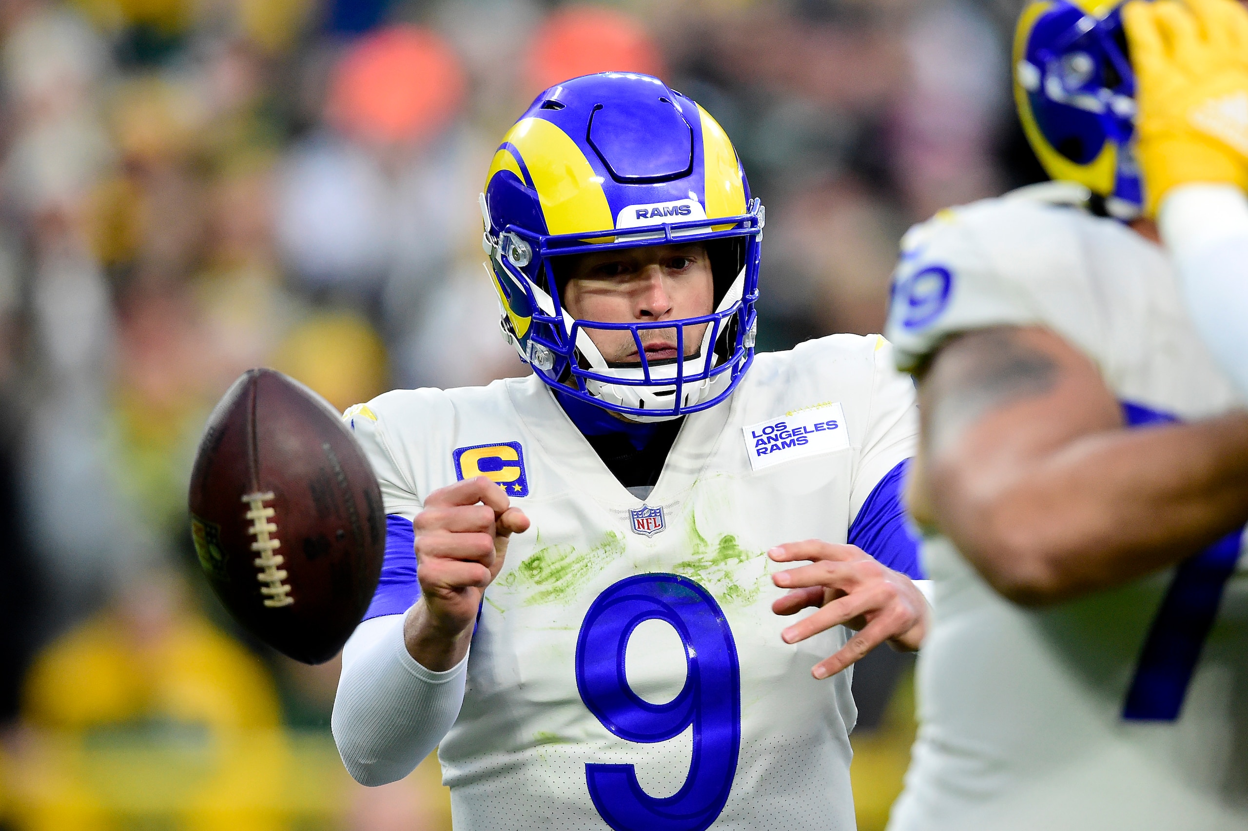 GREEN BAY, WISCONSIN - NOVEMBER 28: Matthew Stafford #9 of the Los Angeles Rams fumbles the ball during the first quarter against the Green Bay Packers at Lambeau Field on November 28, 2021 in Green Bay, Wisconsin. (Photo by Patrick McDermott/Getty Images)