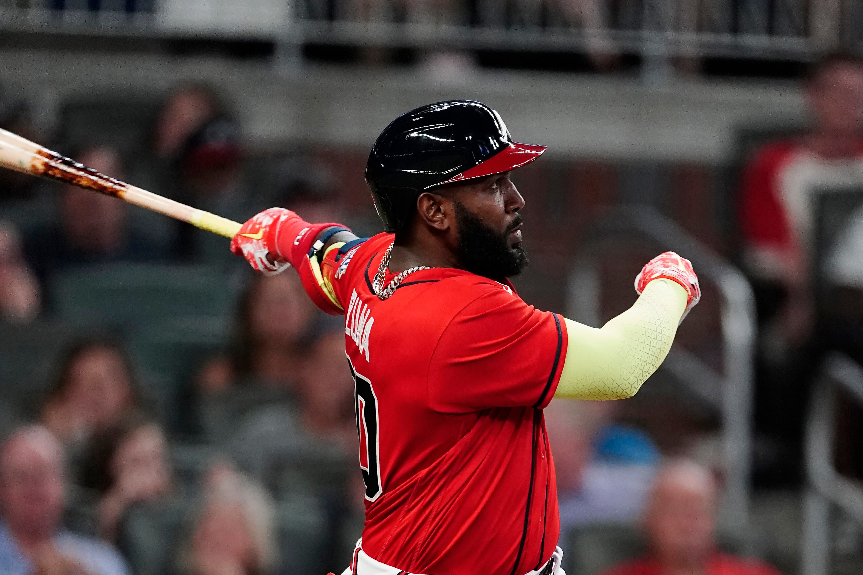 Atlanta Braves' Marcell Ozuna (20) follows through on a solo home run during the sixth inning of the team's baseball game against the Pittsburgh Pirates on Friday, May 21, 2021, in Atlanta. (AP Photo/John Bazemore)