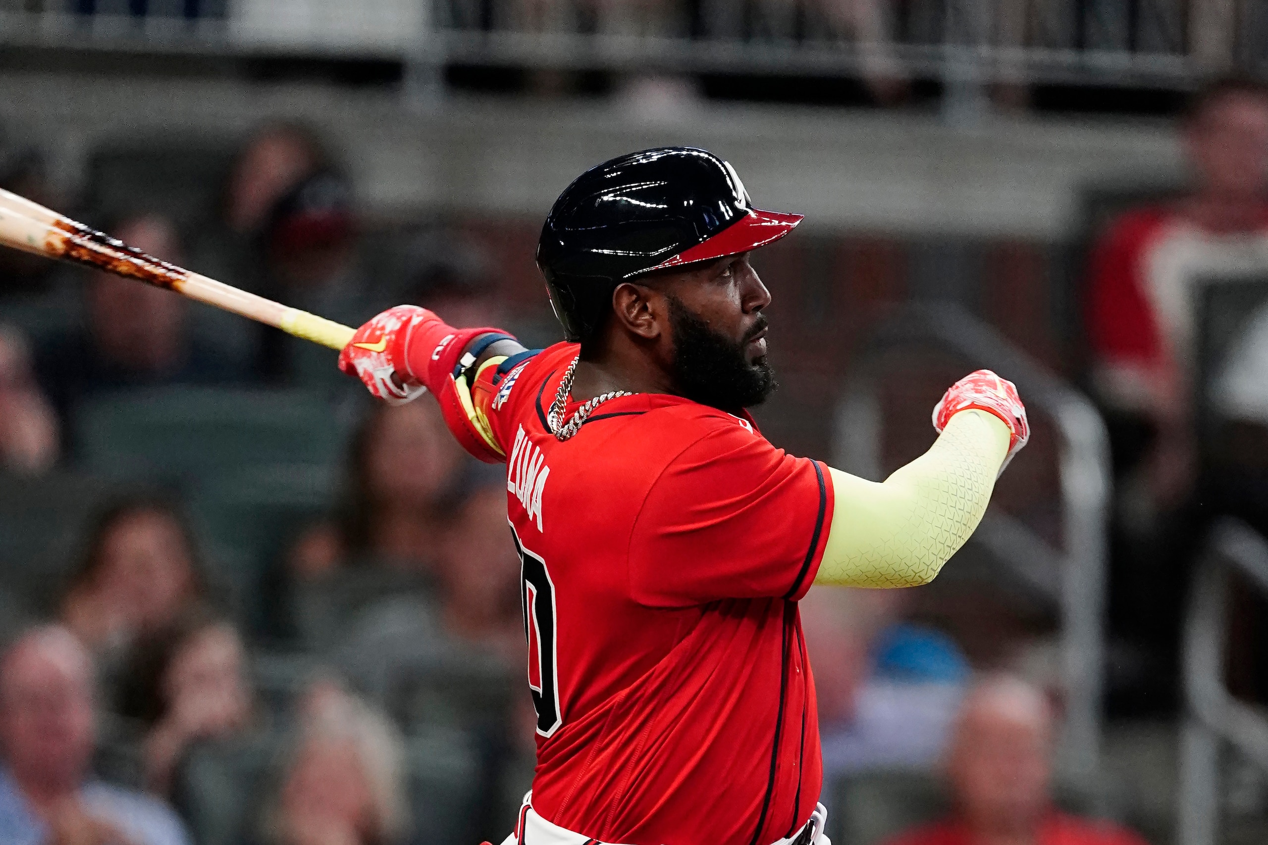 Atlanta Braves' Marcell Ozuna (20) follows through on a solo home run during the sixth inning of the team's baseball game against the Pittsburgh Pirates on Friday, May 21, 2021, in Atlanta. (AP Photo/John Bazemore)