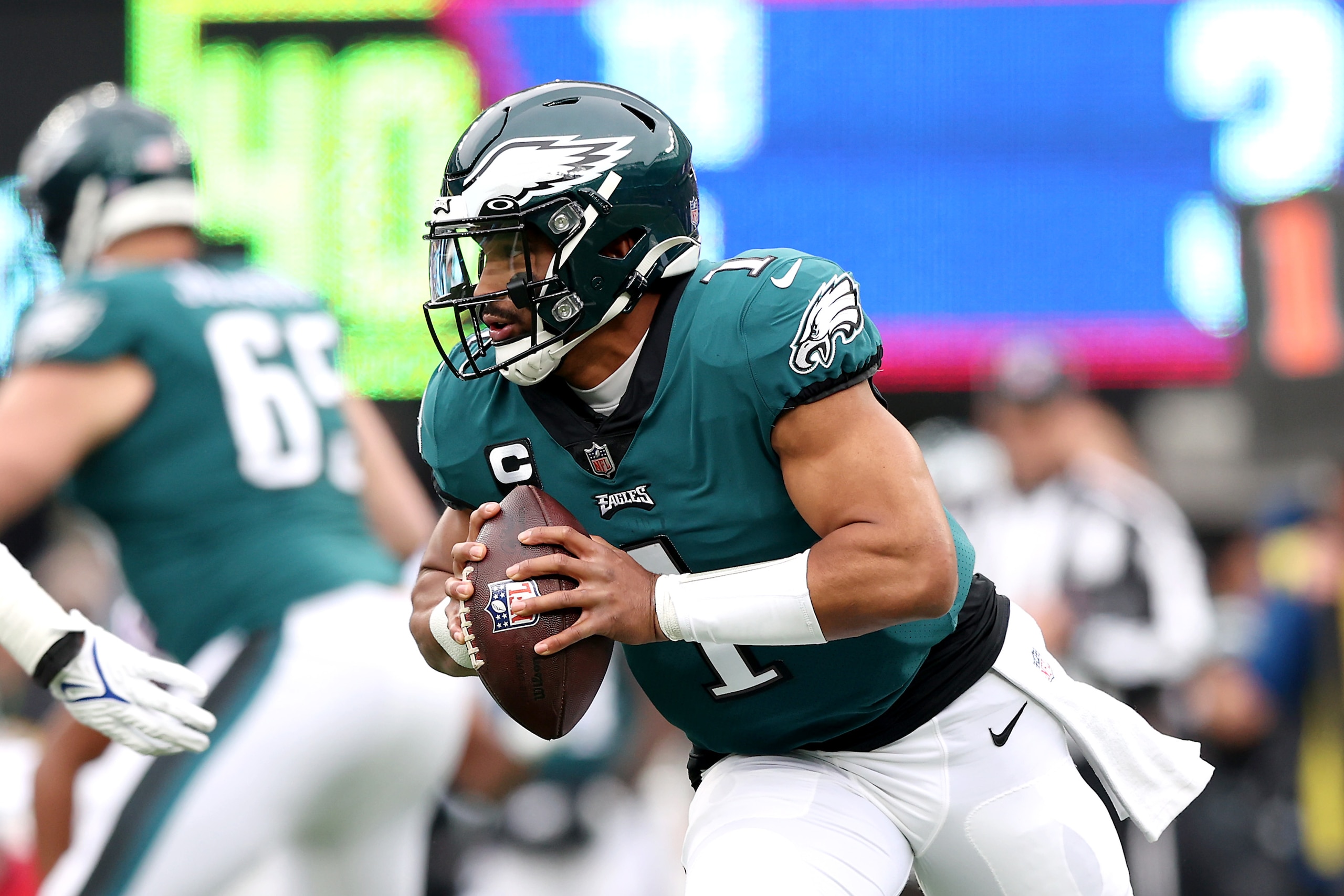 EAST RUTHERFORD, NEW JERSEY - NOVEMBER 28:  Jalen Hurts #1 of the Philadelphia Eagles scrambles for yardage in the first quarter against the New York Giants at MetLife Stadium on November 28, 2021 in East Rutherford, New Jersey. (Photo by Elsa/Getty Images)