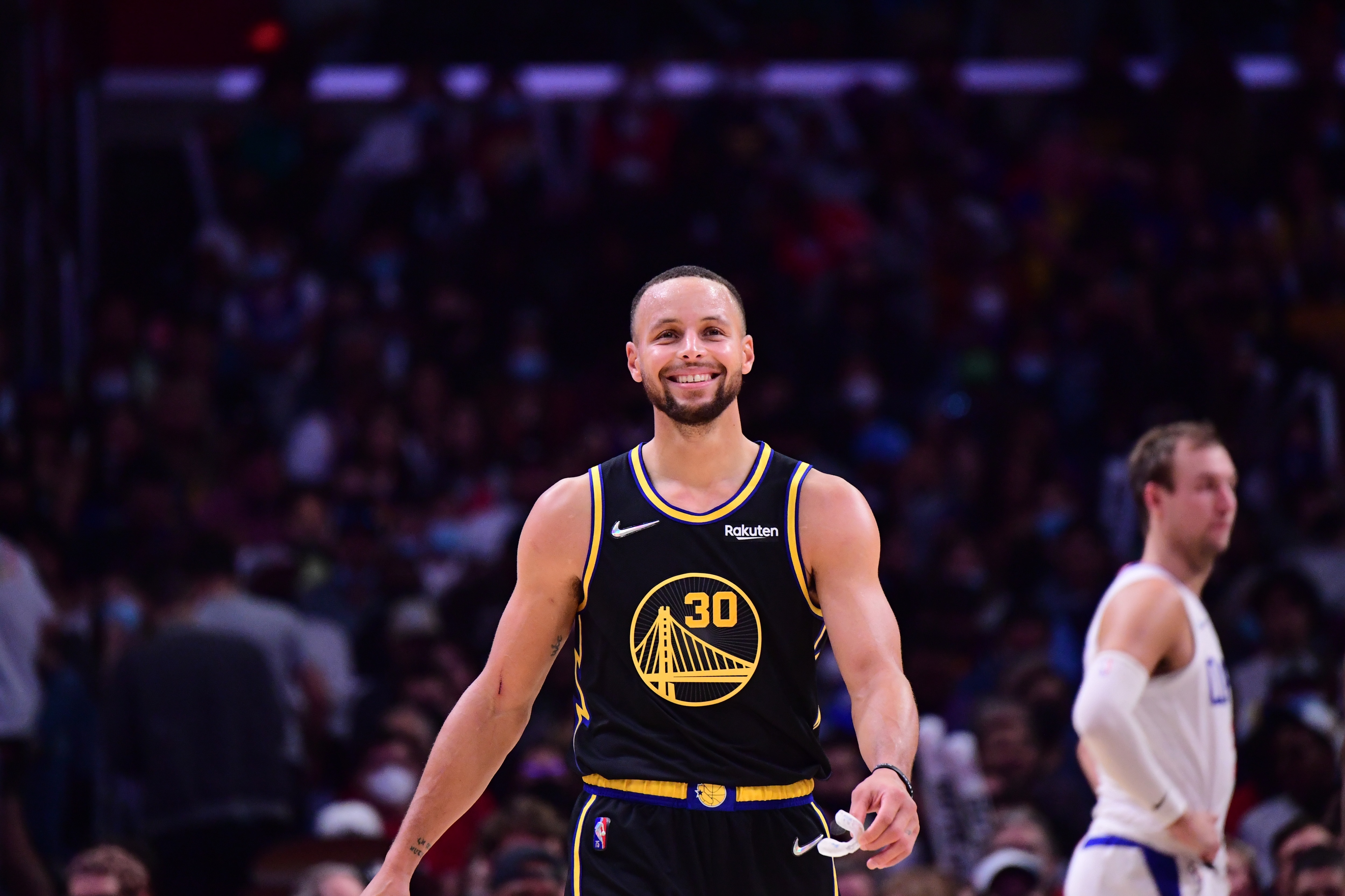 LOS ANGELES, CA - NOVEMBER 28: Stephen Curry #30 of the Golden State Warriors smiles during the game against the LA Clippers on November 28, 2021 at STAPLES Center in Los Angeles, California. NOTE TO USER: User expressly acknowledges and agrees that, by downloading and/or using this Photograph, user is consenting to the terms and conditions of the Getty Images License Agreement. Mandatory Copyright Notice: Copyright 2021 NBAE (Photo by Adam Pantozzi/NBAE via Getty Images)