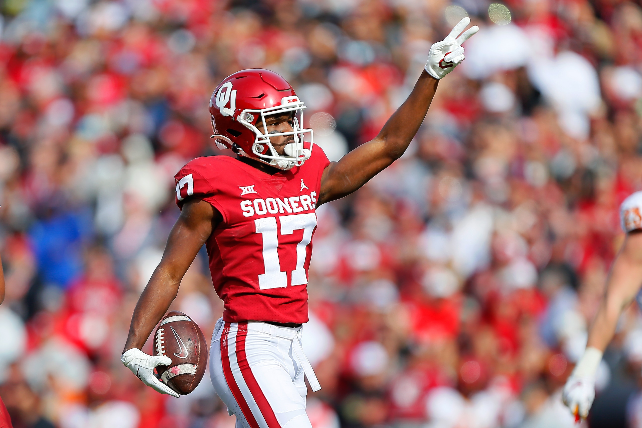NORMAN, OK - NOVEMBER 20:  Wide receiver Marvin Mims #17 of the Oklahoma Sooners points for a first down after making a 22-yard catch to the 12-yard line against the Iowa State Cyclones in the third quarter at Gaylord Family Oklahoma Memorial Stadium on November 20, 2021 in Norman, Oklahoma.  The Sooners won 28-21.  (Photo by Brian Bahr/Getty Images)