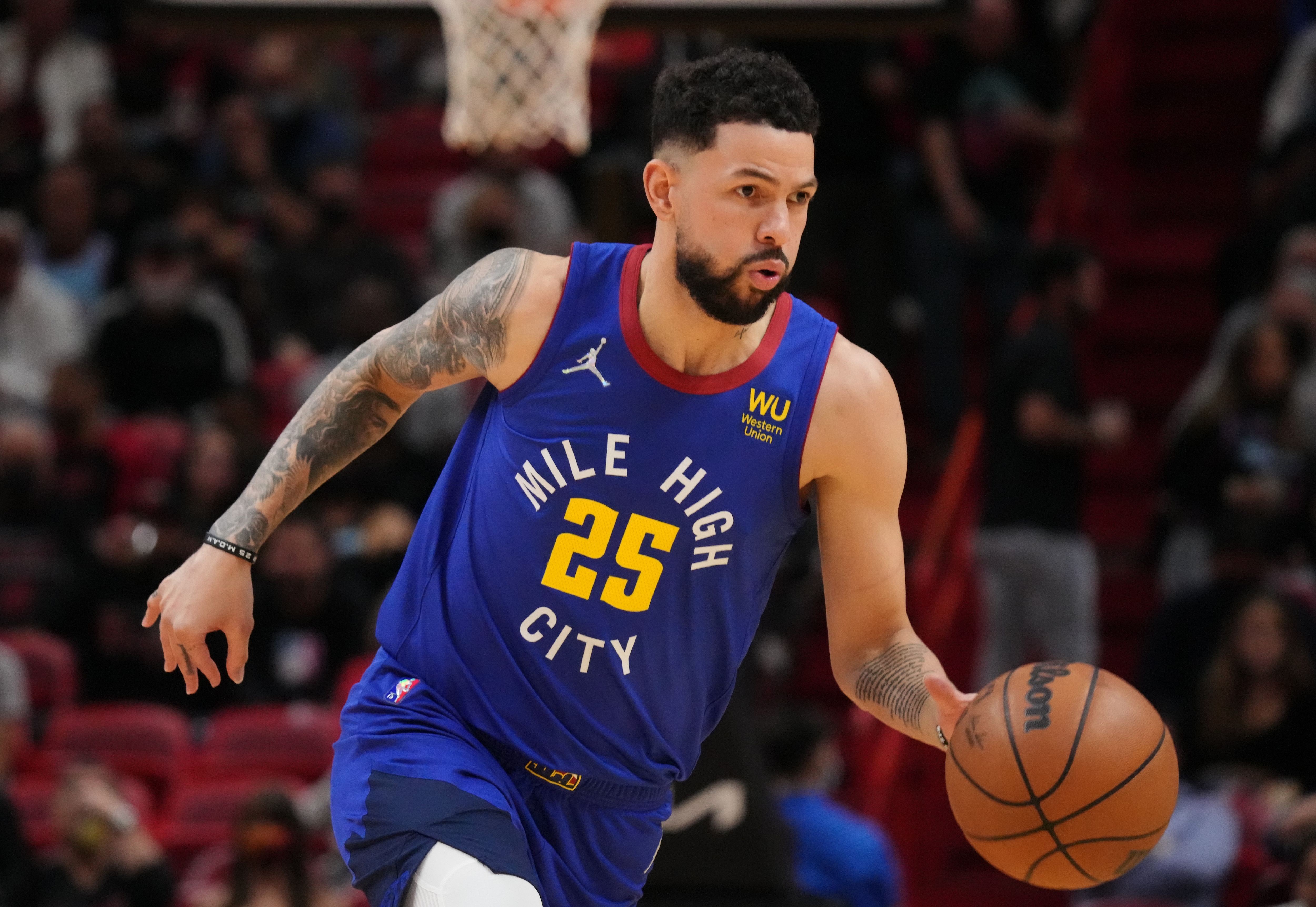 MIAMI, FLORIDA - NOVEMBER 29: Austin Rivers #25 of the Denver Nuggets dribbles the ball up the court against the Miami Heat during the first half at FTX Arena on November 29, 2021 in Miami, Florida. NOTE TO USER: User expressly acknowledges and agrees that, by downloading and or using this photograph, User is consenting to the terms and conditions of the Getty Images License Agreement. (Photo by Mark Brown/Getty Images)