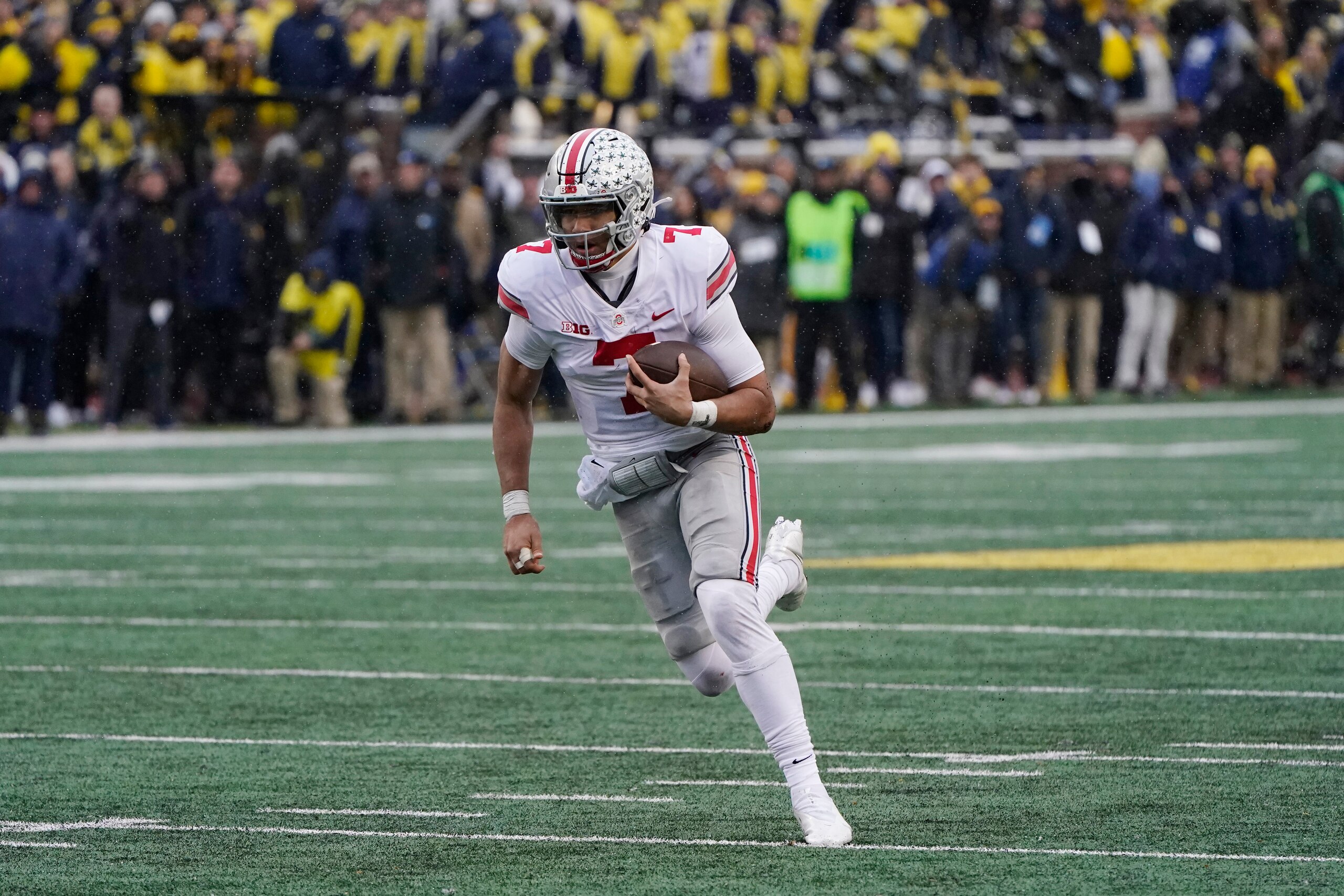 Ohio State quarterback C.J. Stroud scrambles during the second half of an NCAA college football game against Michigan, Saturday, Nov. 27, 2021, in Ann Arbor, Mich. (AP Photo/Carlos Osorio)