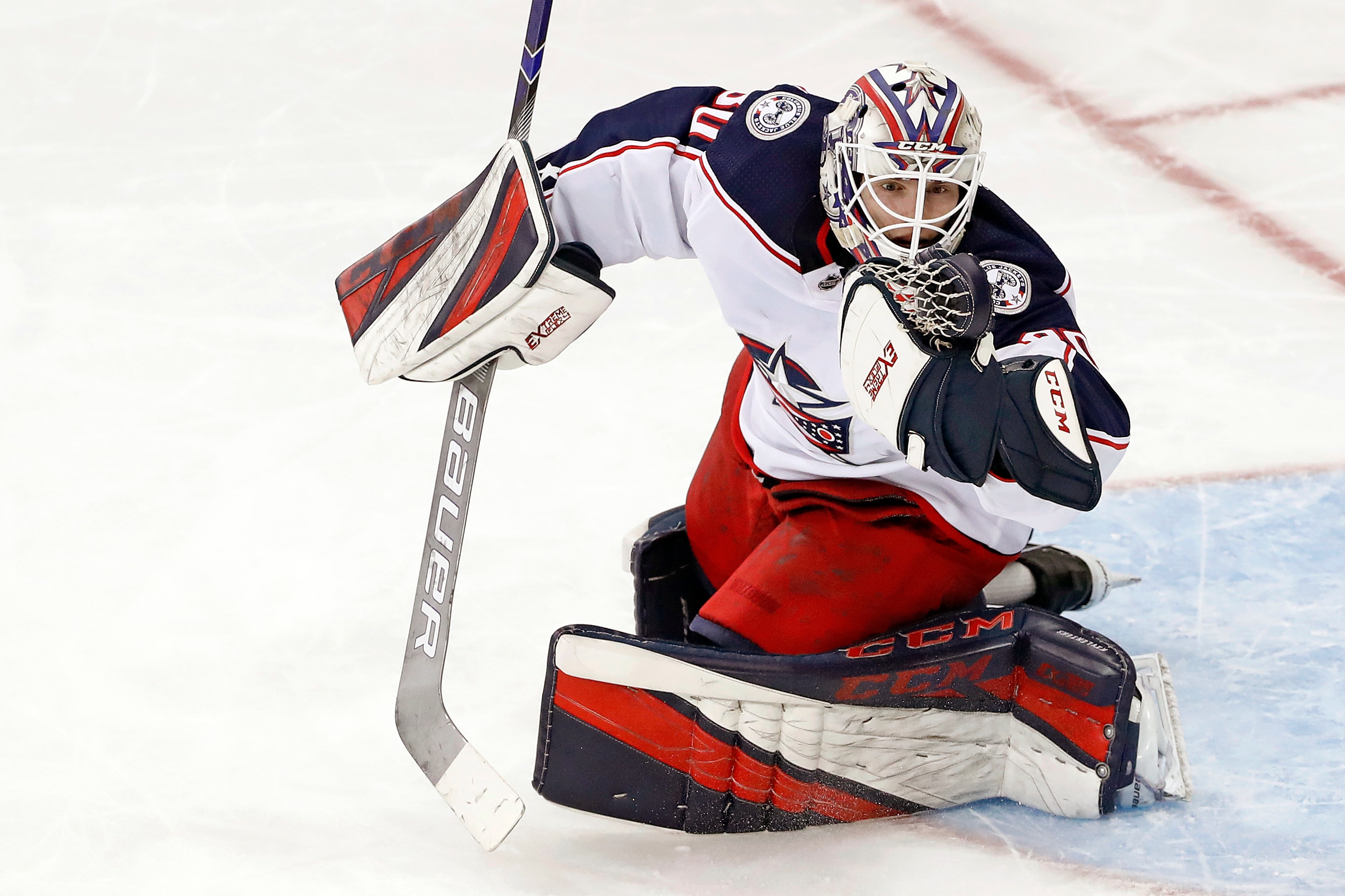 Columbus Blue Jackets goaltender Matiss Kivlenieks (80) has the puck in his hand as he makes a save during the third period of an NHL hockey game against the New York Rangers Sunday, Jan. 19, 2020, in New York. The Blue Jackets defeated the Rangers 2-1. (AP Photo/Kathy Willens)
