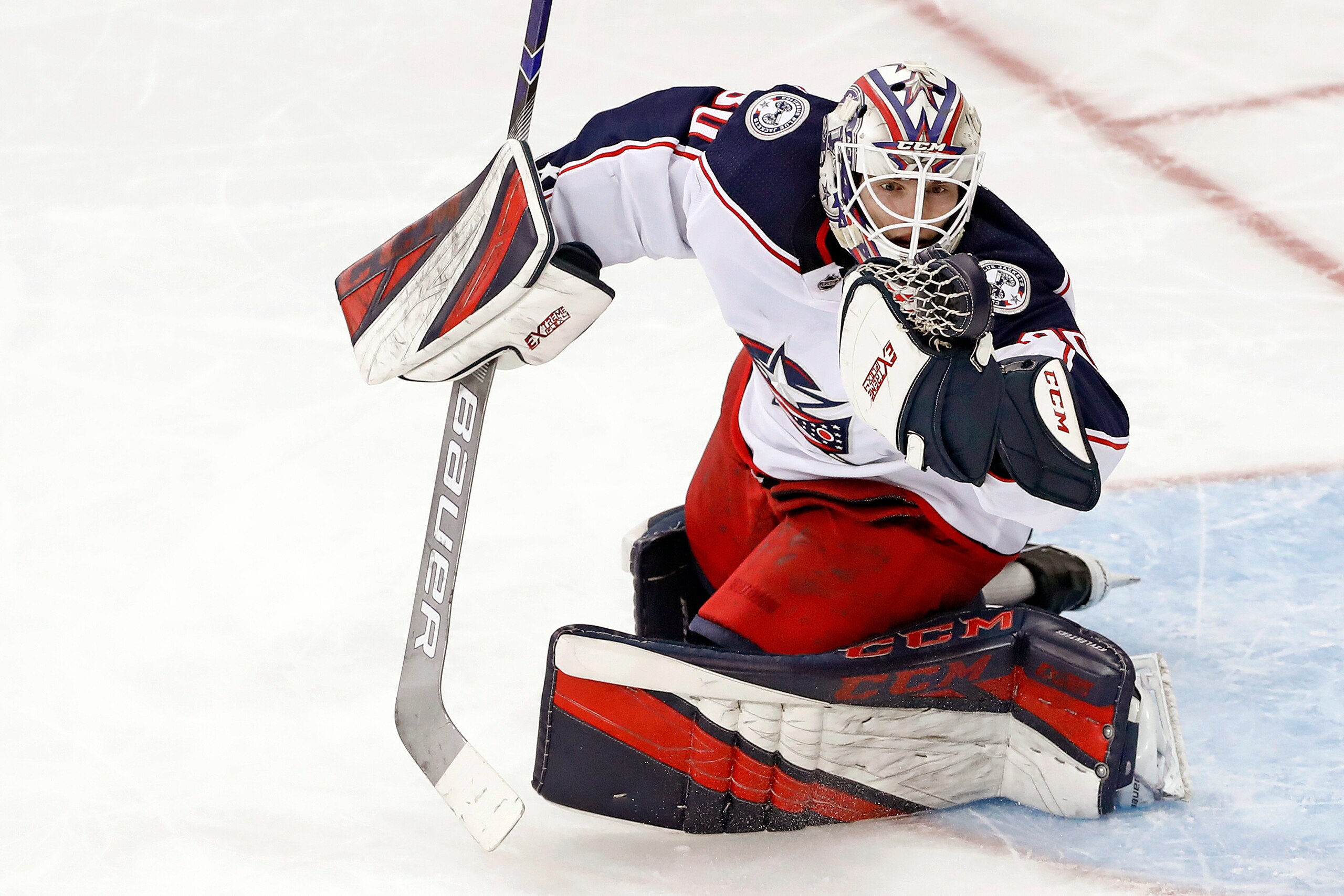Columbus Blue Jackets goaltender Matiss Kivlenieks (80) has the puck in his hand as he makes a save during the third period of an NHL hockey game against the New York Rangers Sunday, Jan. 19, 2020, in New York. The Blue Jackets defeated the Rangers 2-1. (AP Photo/Kathy Willens)