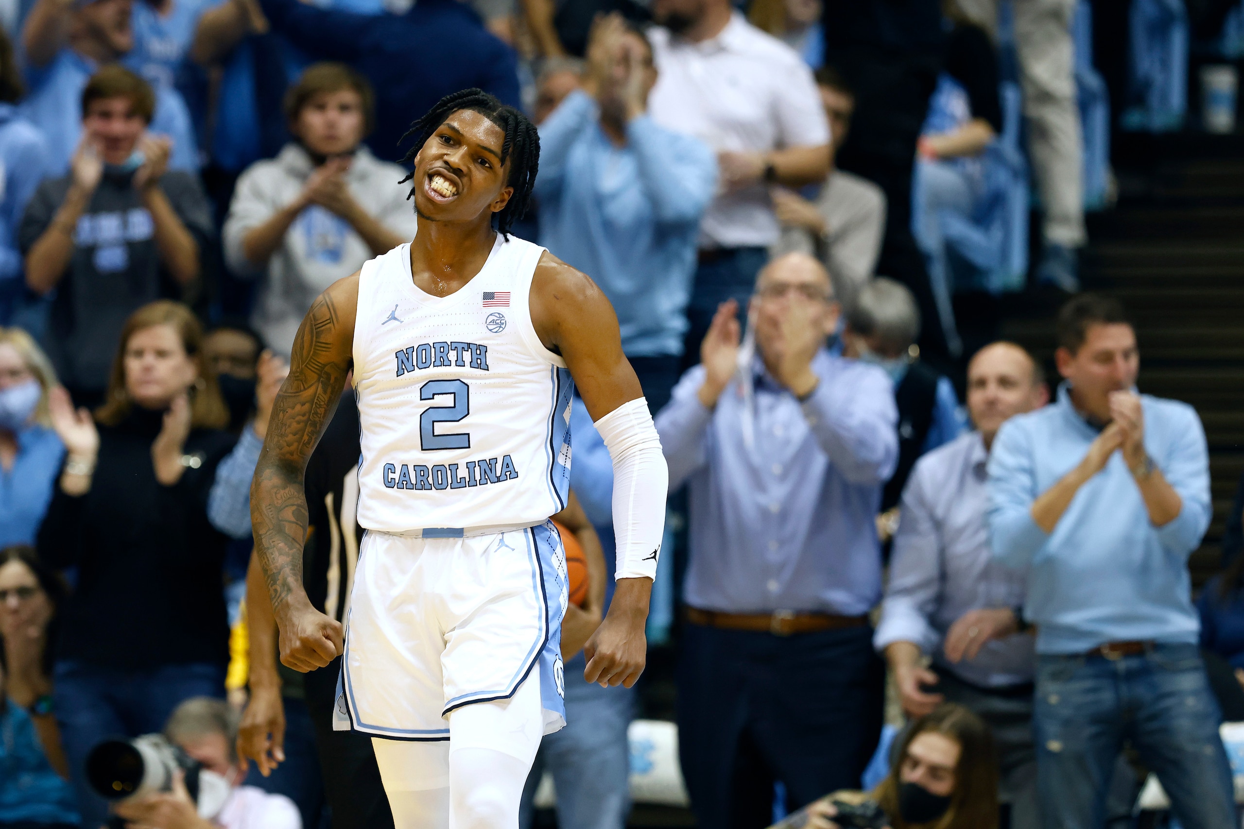 CHAPEL HILL, NORTH CAROLINA - DECEMBER 01: Caleb Love #2 of the North Carolina Tar Heels reacts after making a three-point basket against the Michigan Wolverines during the first half of their game at the Dean E. Smith Center on December 01, 2021 in Chapel Hill, North Carolina. (Photo by Grant Halverson/Getty Images)