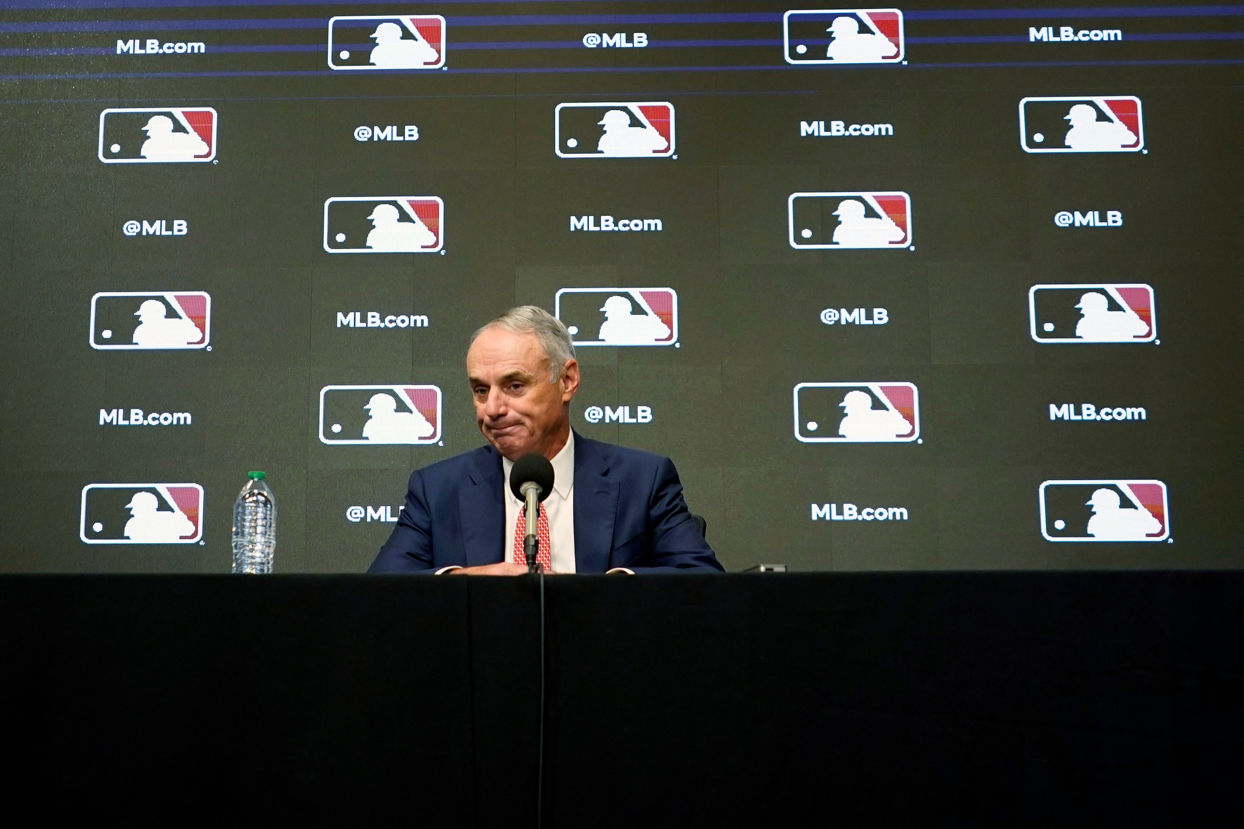 Major League Baseball commissioner Rob Manfred pauses during a news conference in Arlington, Texas, Thursday, Dec. 2, 2021. Owners locked out players at 12:01 a.m. Thursday following the expiration of the sport's five-year collective bargaining agreement. (AP Photo/LM Otero)