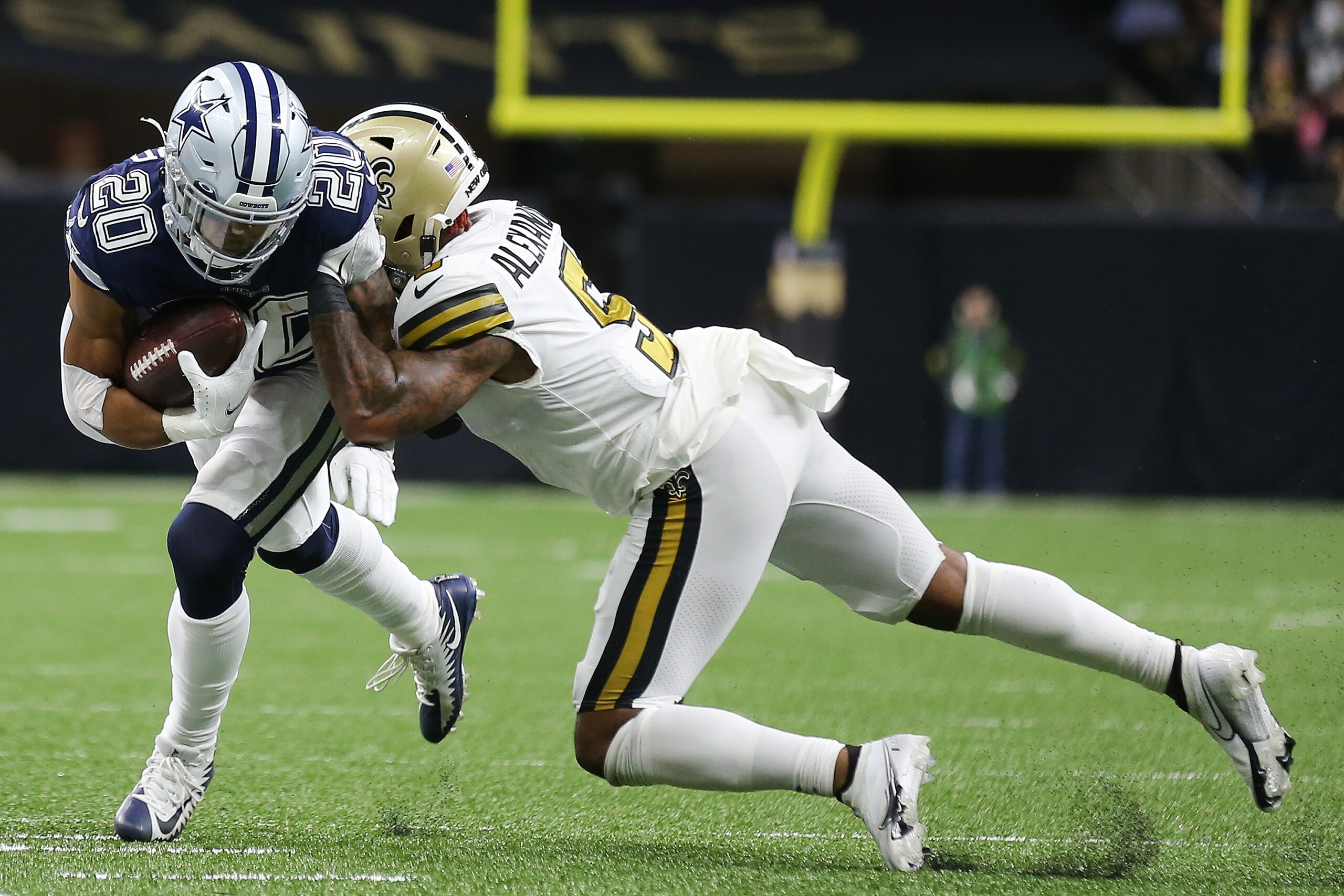 NEW ORLEANS, LOUISIANA - DECEMBER 02: Tony Pollard #20 of the Dallas Cowboys is tackled by Kwon Alexander #5 of the New Orleans Saints in the second quarter of the game at Caesars Superdome on December 02, 2021 in New Orleans, Louisiana. (Photo by Jonathan Bachman/Getty Images)