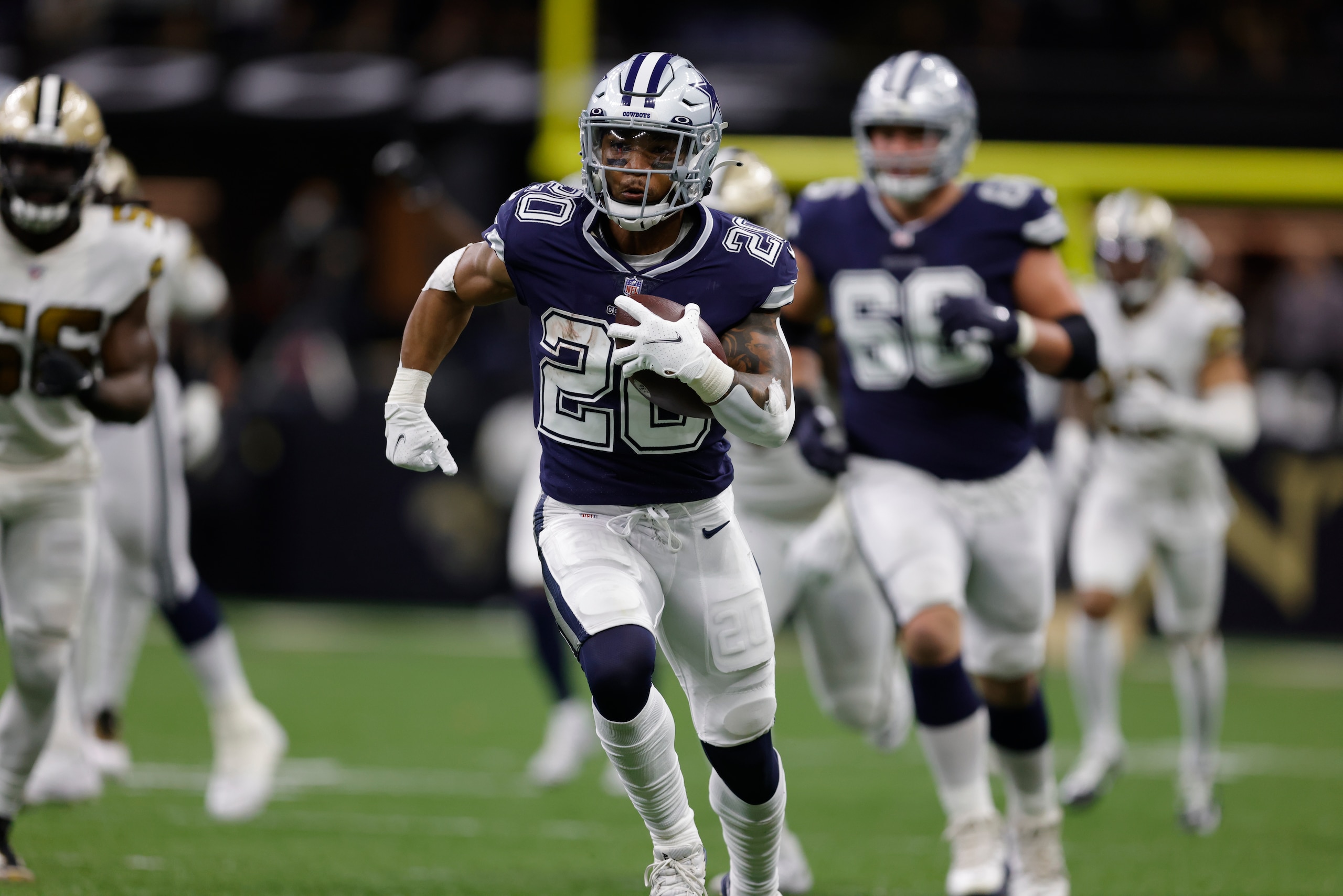 Dallas Cowboys running back Tony Pollard (20) runs against the New Orleans Saints during the second half of an NFL football game, Thursday, Dec. 2, 2021, in New Orleans. (AP Photo/Brett Duke) Dallas Cowboys running back Tony Pollard (20) runs against the New Orleans Saints during the second half of an NFL football game, Thursday, Dec. 2, 2021, in New Orleans. (AP Photo/Brett Duke)