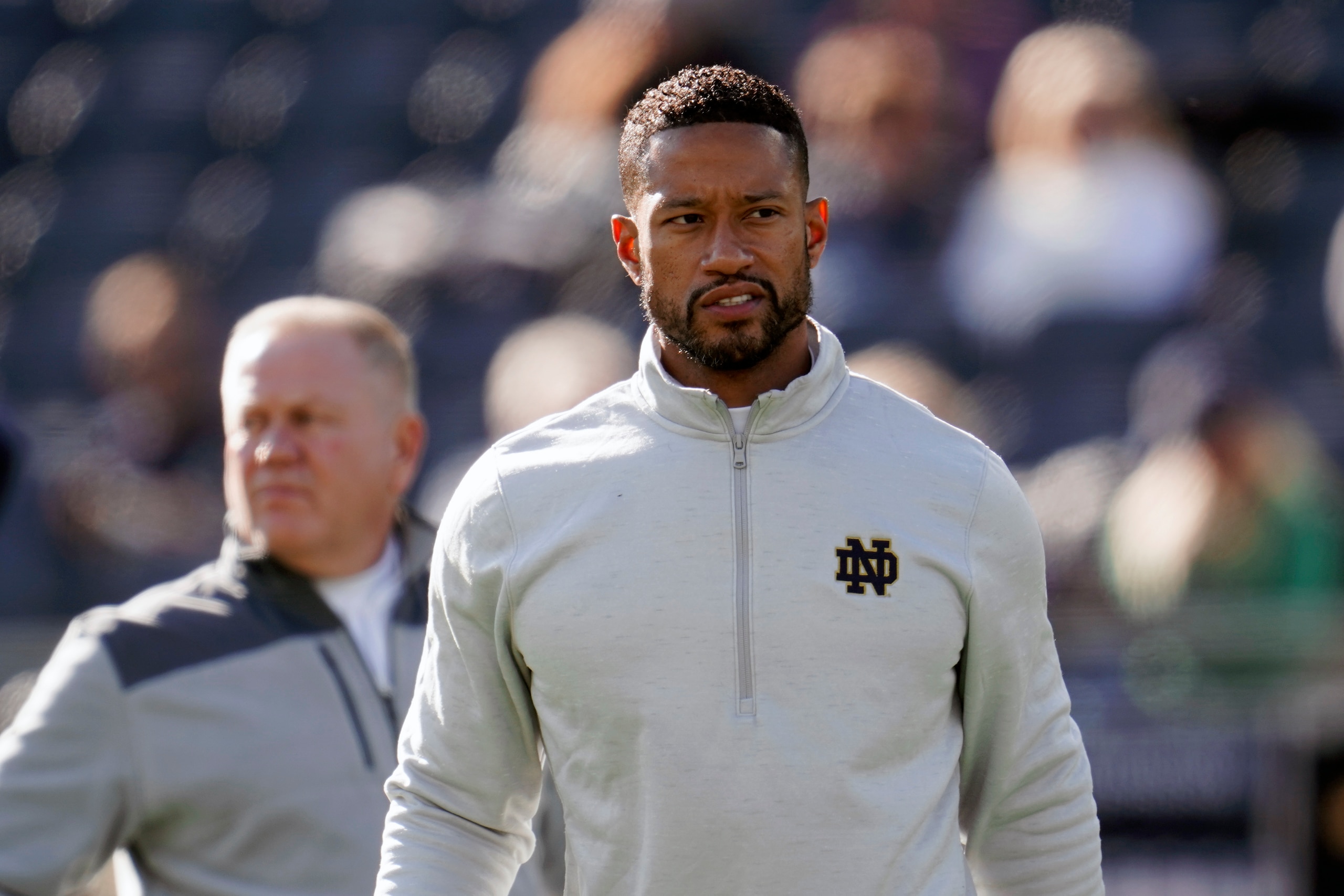 FILE - Notre Dame defensive coordinator Marcus Freeman watches during warmups before an NCAA college football game against Navy in South Bend, Ind., Saturday, Nov. 6, 2021. Notre Dame is working on a deal to promote defensive coordinator Marcus Freeman to head coach to replace Brian Kelly, a person with knowledge of the situation told The Associated Press on Wednesday night, Dec. 1, 2021. (AP Photo/Paul Sancya, File) FILE - Notre Dame defensive coordinator Marcus Freeman watches during warmups before an NCAA college football game against Navy in South Bend, Ind., Saturday, Nov. 6, 2021. Notre Dame is working on a deal to promote defensive coordinator Marcus Freeman to head coach to replace Brian Kelly, a person with knowledge of the situation told The Associated Press on Wednesday night, Dec. 1, 2021. (AP Photo/Paul Sancya, File)